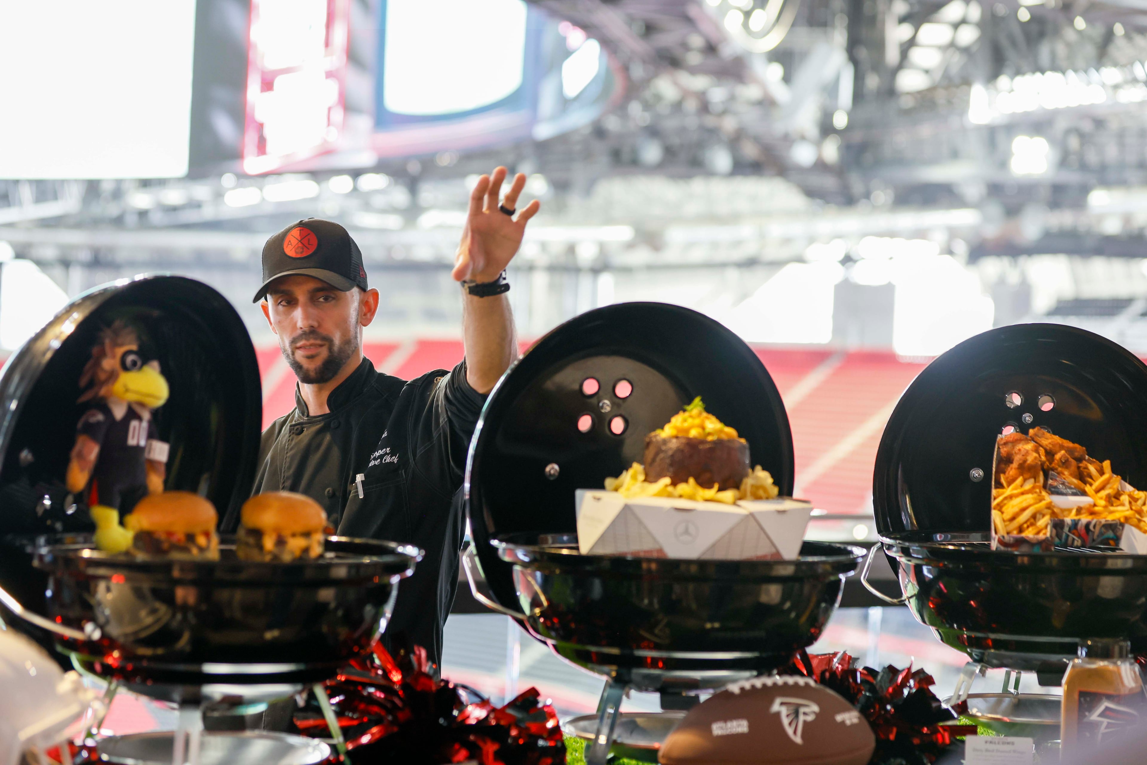 Matthew Cooper, senior executive chef of Levy Restaurants, shows off some of the new items that will be served at the Sports Illustrated Lounge during a food tasting on Thursday, Aug. 14, 2025, at Mercedes-Benz Stadium in Atlanta. (Miguel Martinez/AJC)