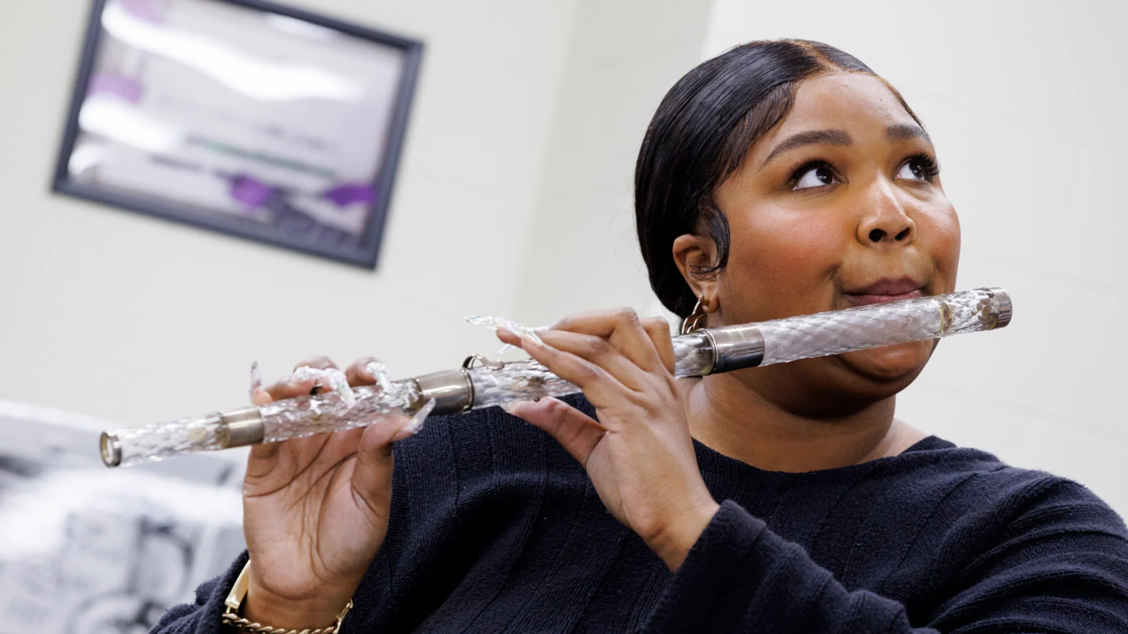 A photo provided by Shawn Miller and the Library of Congress shows Lizzo practicing with James Madison’s flute before bringing it onstage during her concert at Capital One Arena in Washington. A classically trained flutist, the singer, rapper and songwriter spent more than three hours admiring the flute collection at the Library of Congress. (Shawn Miller/Library of Congress via The New York Times) — EDITORIAL USE ONLY—