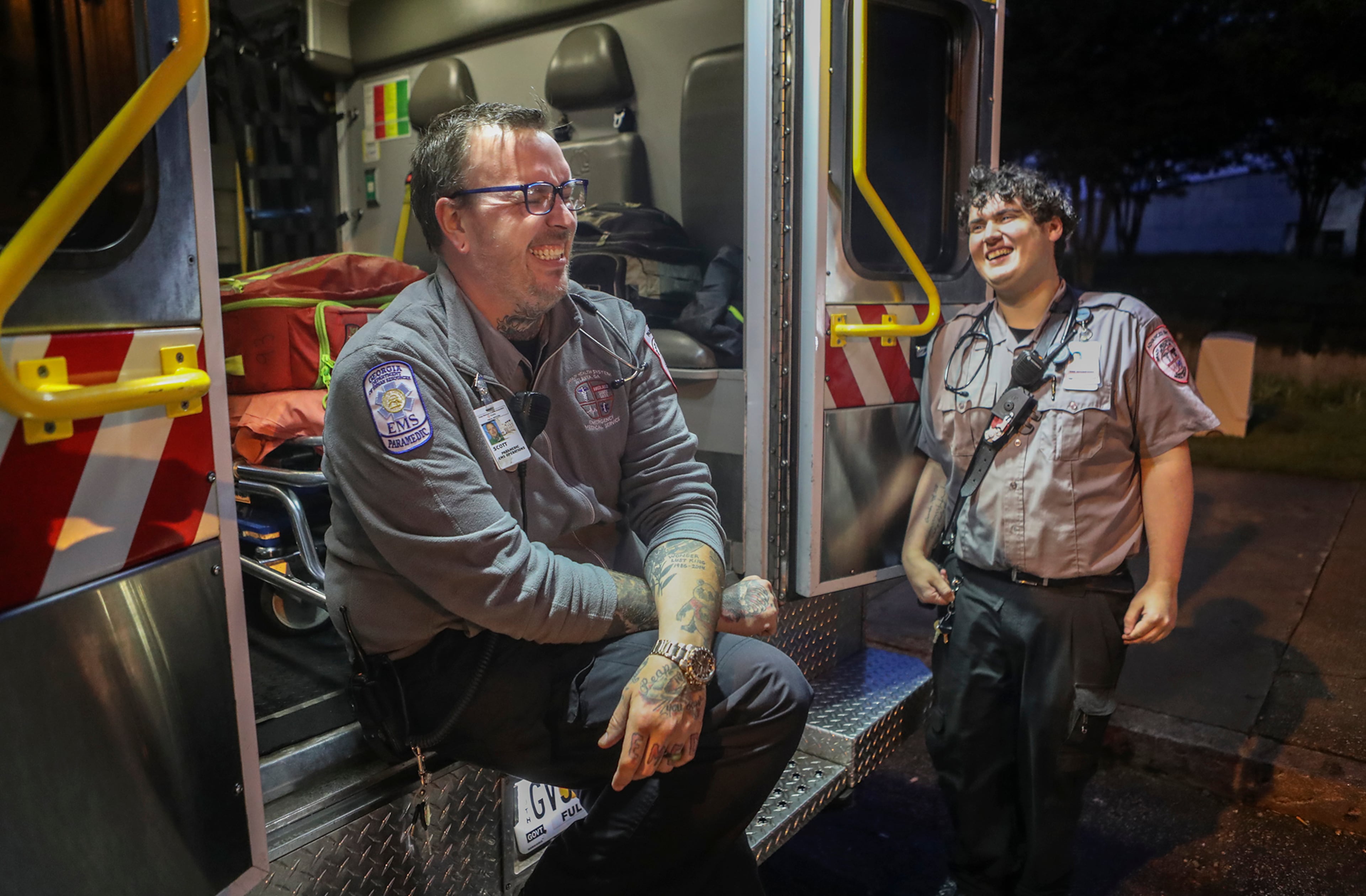 May 19, 2020 Atlanta: Grady EMS paramedic, Scott Barker (left) shares a laugh between calls with advanced emergency medical technician, Stephen Beam (right) at Grady hospital on Tuesday, May 19, 2020. Paramedic Scott Barker said, "My service during this pandemic has been very important to me. We're really out there able to help people one hundred per cent when they feel they're scared and really don't understand what's going on, we're there to really be the light to help them differentiate between what's life threatening and what's not life threatening and being the guiding light for their health" Reflecting on the pandemic, Advanced EMT, Stephen Beam said, "It's very important, we have a lot of sick people in Atlanta we have to care for and we don't know who is sick, so obviously we have to take all precautions with every single patient. It means a lot that I'm helping all these people." Barker has been a paramedic for Grady for 15-years and in the EMS service for 18-years and Beam for 2-years. JOHN SPINK/JSPINK@AJC.COM