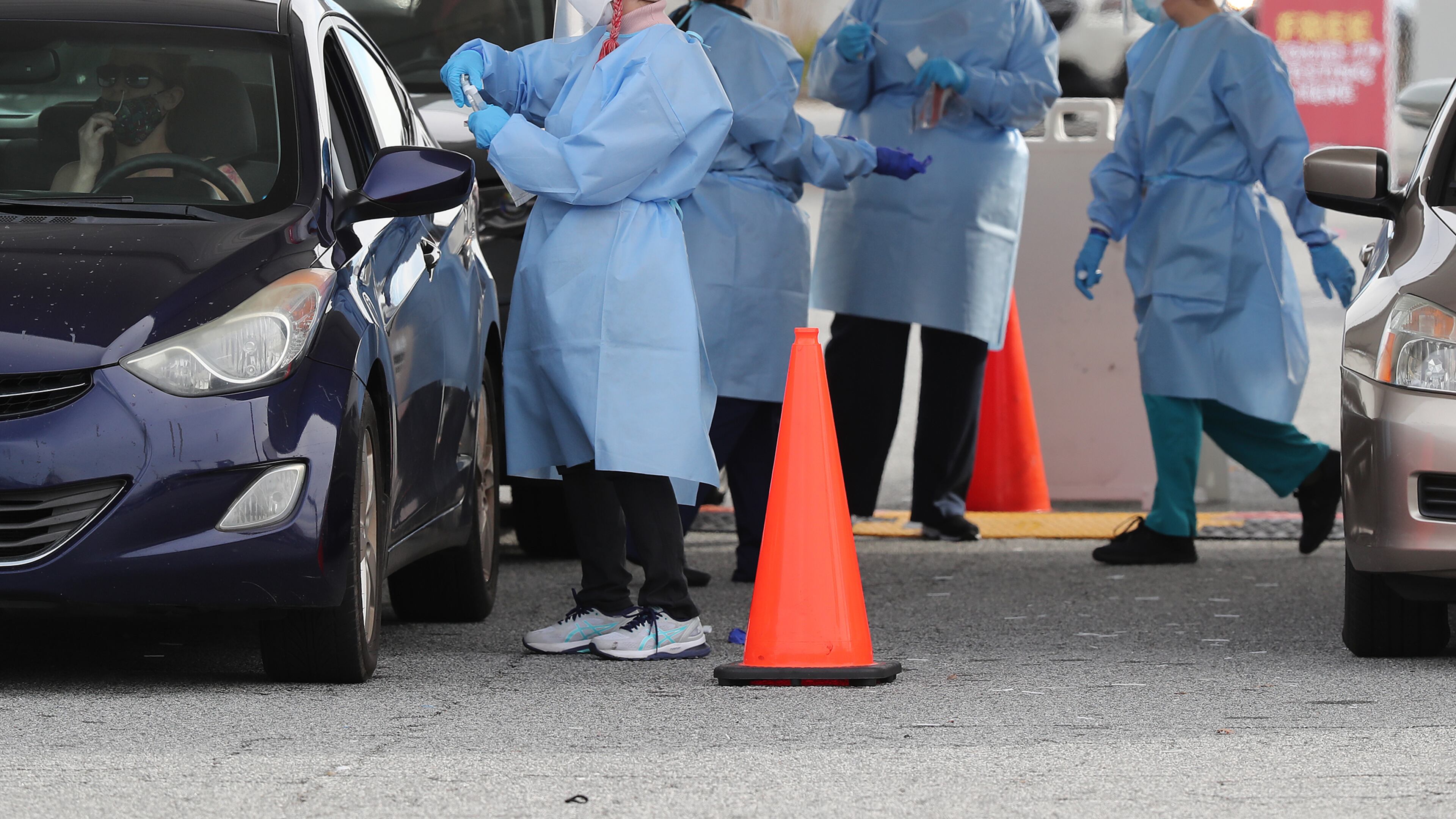 122320 Doraville: RN Elham Roshanraun (left) and other nurses work a line of motorists at a free drive through COVID-19 DeKalb Board of Health testing site located by the Brandsmart USA while coronavirus testing surges as Christmas nears on Wednesday, Dec. 23, 2020, in Doraville. “Curtis Compton / Curtis.Compton@ajc.com”