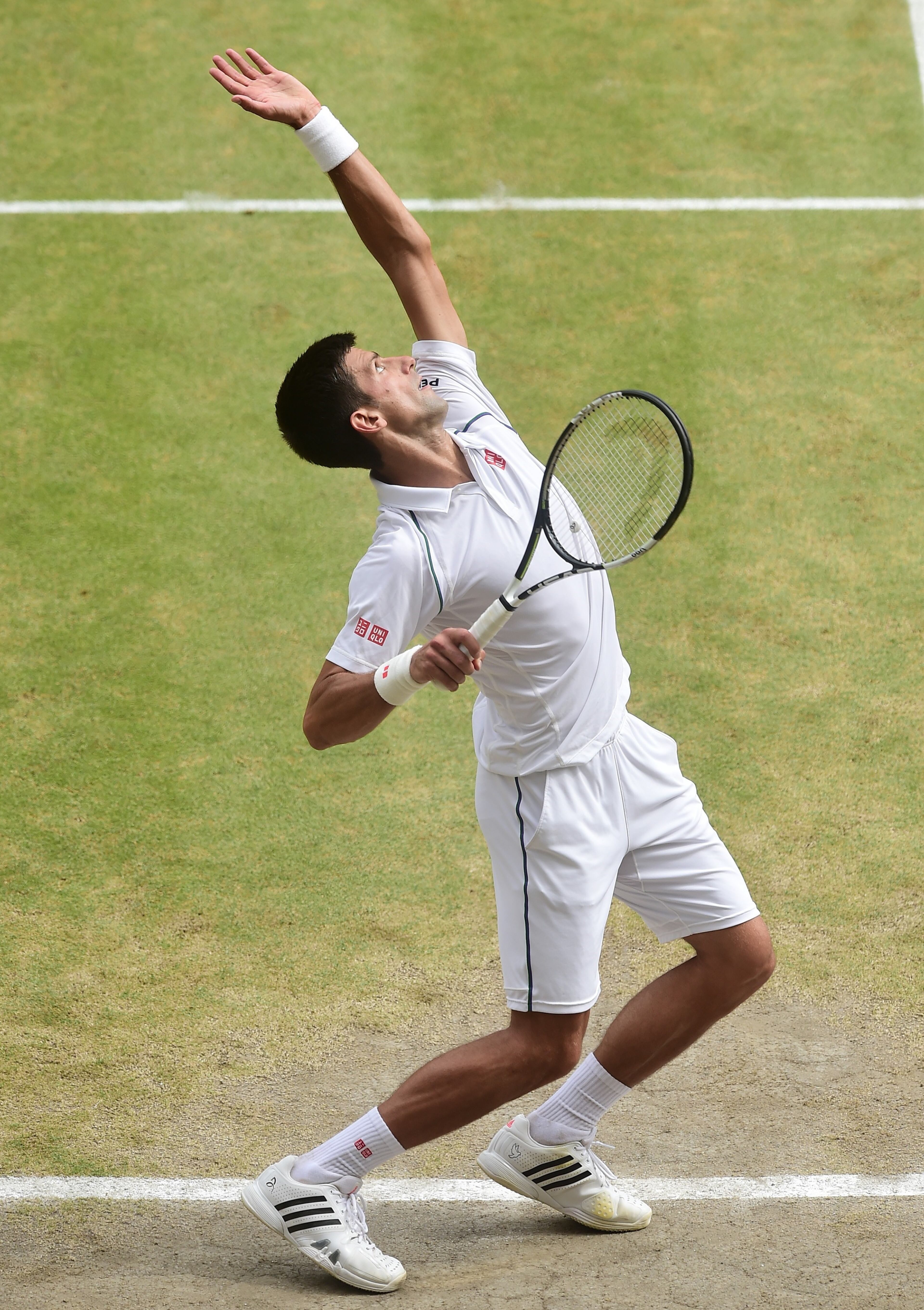 LONDON, ENGLAND - JULY 12: Novak Djokovic of Serbia serves against Roger Federer of Switzerland during the Final of the Gentlemen's Singles on day thirteen of the Wimbledon Lawn Tennis Championships at the All England Lawn Tennis and Croquet Club on July 12, 2015 in London, England. (Photo by Alex Broadway/Anadolu Agency/Getty Images)
