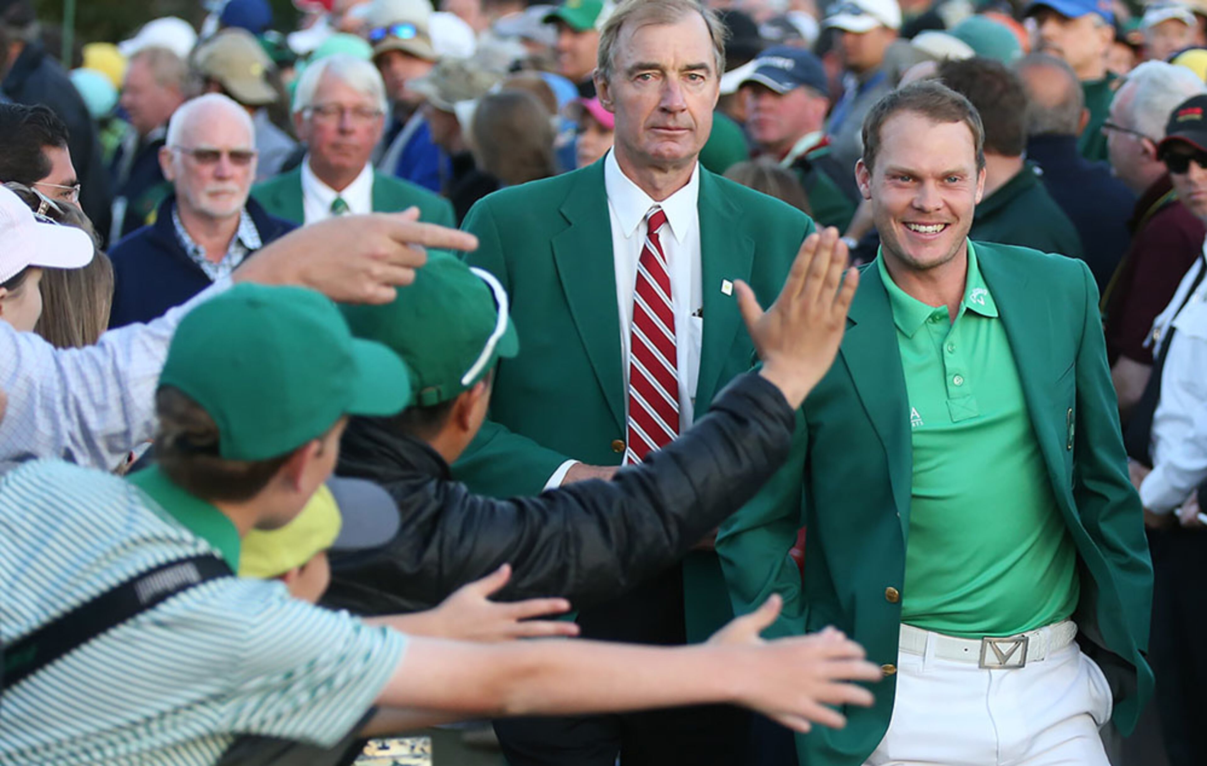 Fans cheer and high five Danny Willett as he leaves the green jacket ceremony after winning the Masters at Augusta National Golf Club on Sunday, April 10, 2016, in Augusta.