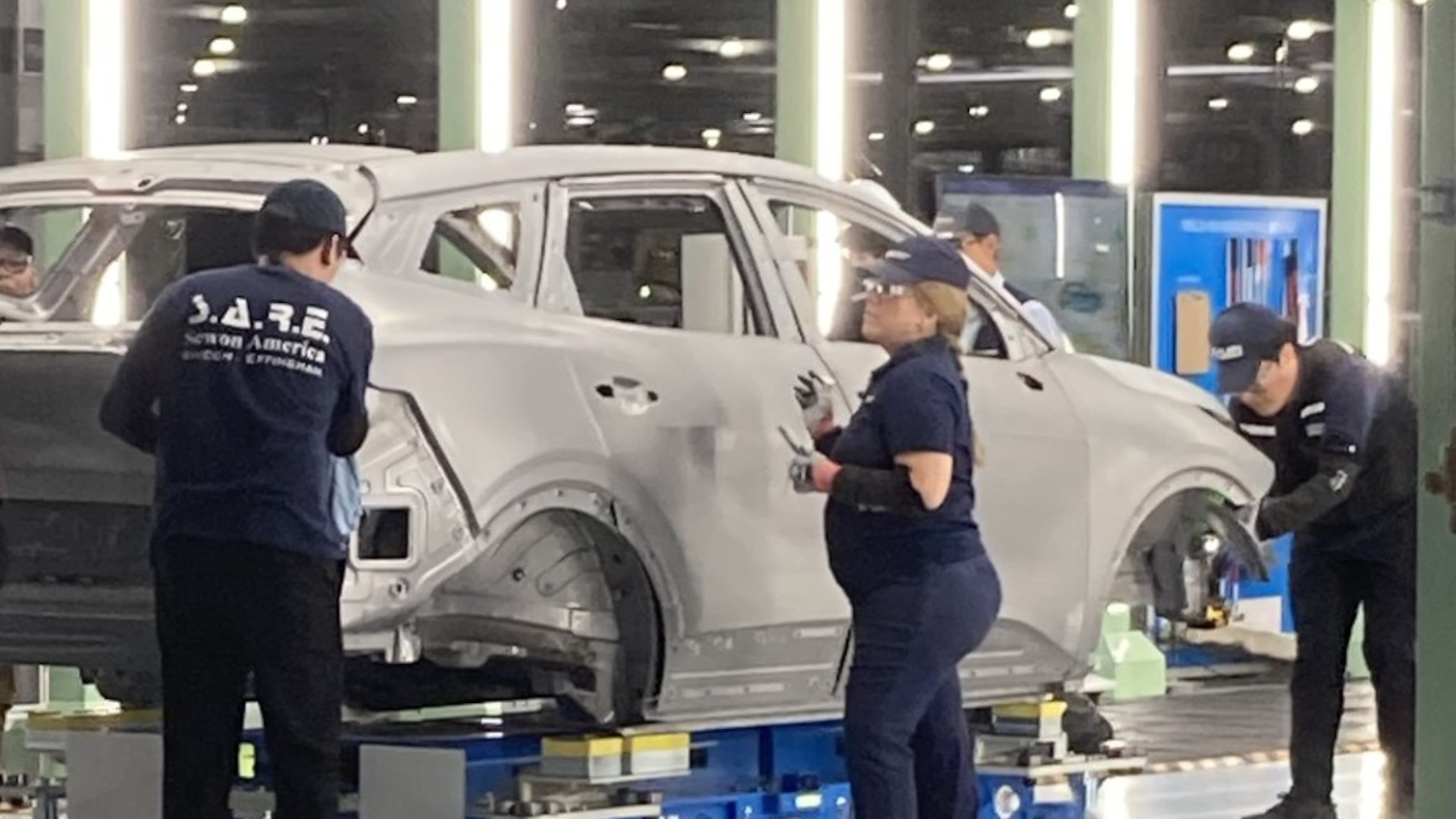 Hyundai factory workers, known as metapros, inspect a Kia Sportage hybrid autobody during the manufacturing process on Tuesday, June 2, 2026, at the Hyundai Metaplant near Savannah, Georgia. (Adam Van Brimmer/AJC)