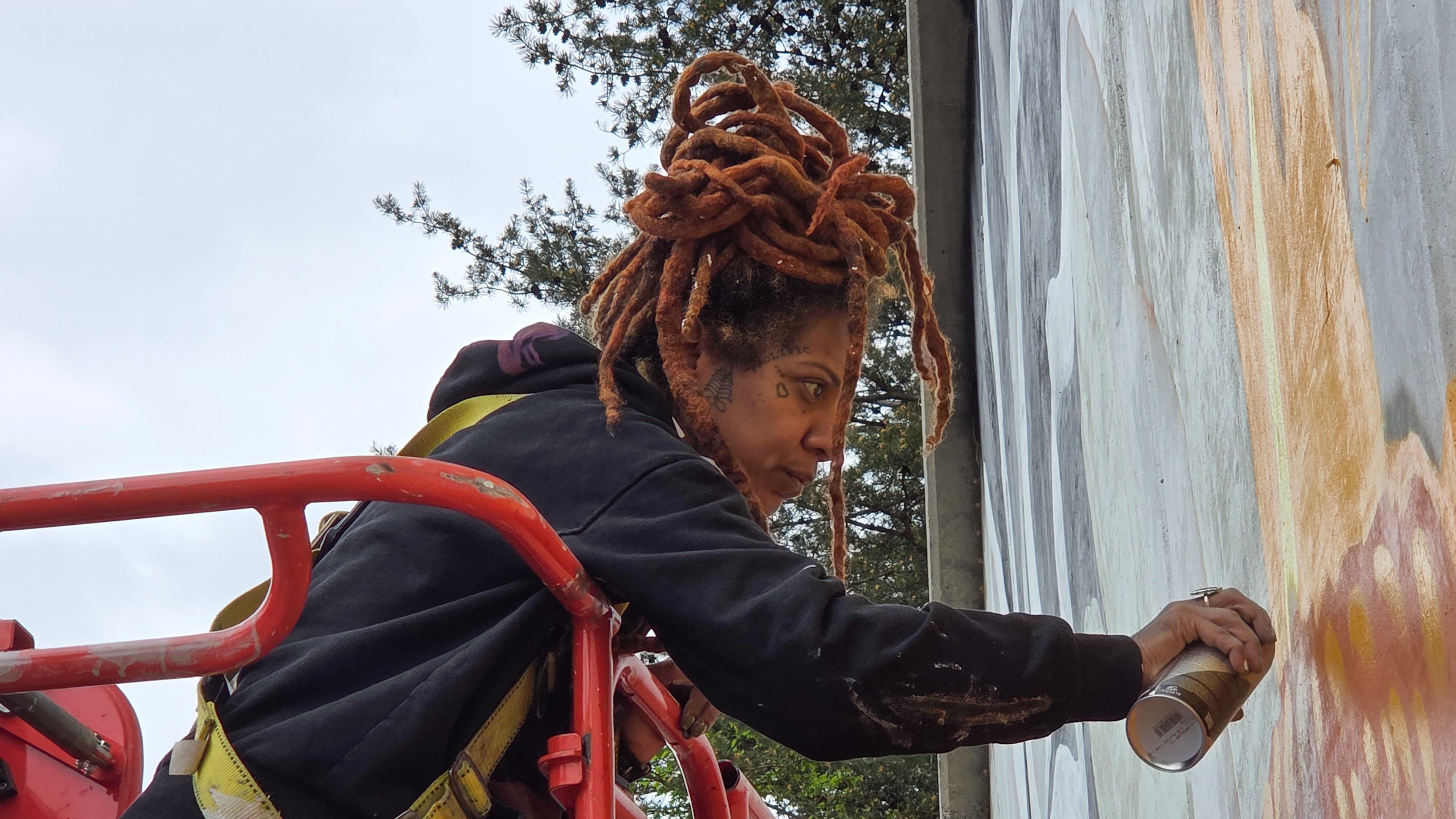 Artist Charity Hamidullah readies her mural "Wild Seed, Wild Flower" in preparation for the World Cup. (Courtesy of Arthur Rudick)