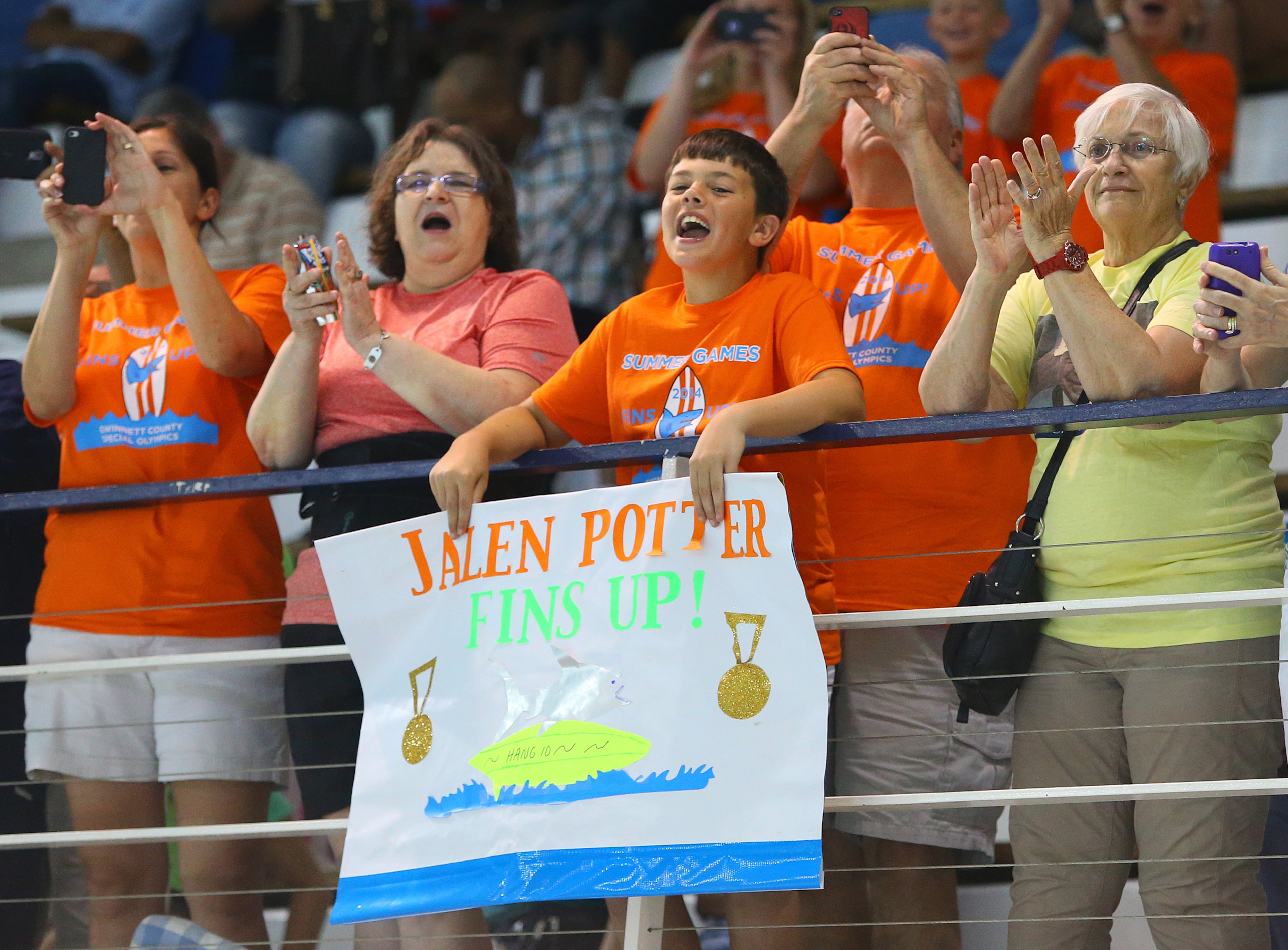 Jalen Potter, 9, Buford, has his own cheering section that includes his brother Bricen Potter, 11, (center) with a sign of support as he cheers his brother on to a gold medal in the 15 Meter Flotation event at the Special Olympics Georgia State Summer Games at Emory University on Sunday, June 1, 2014, in Atlanta.