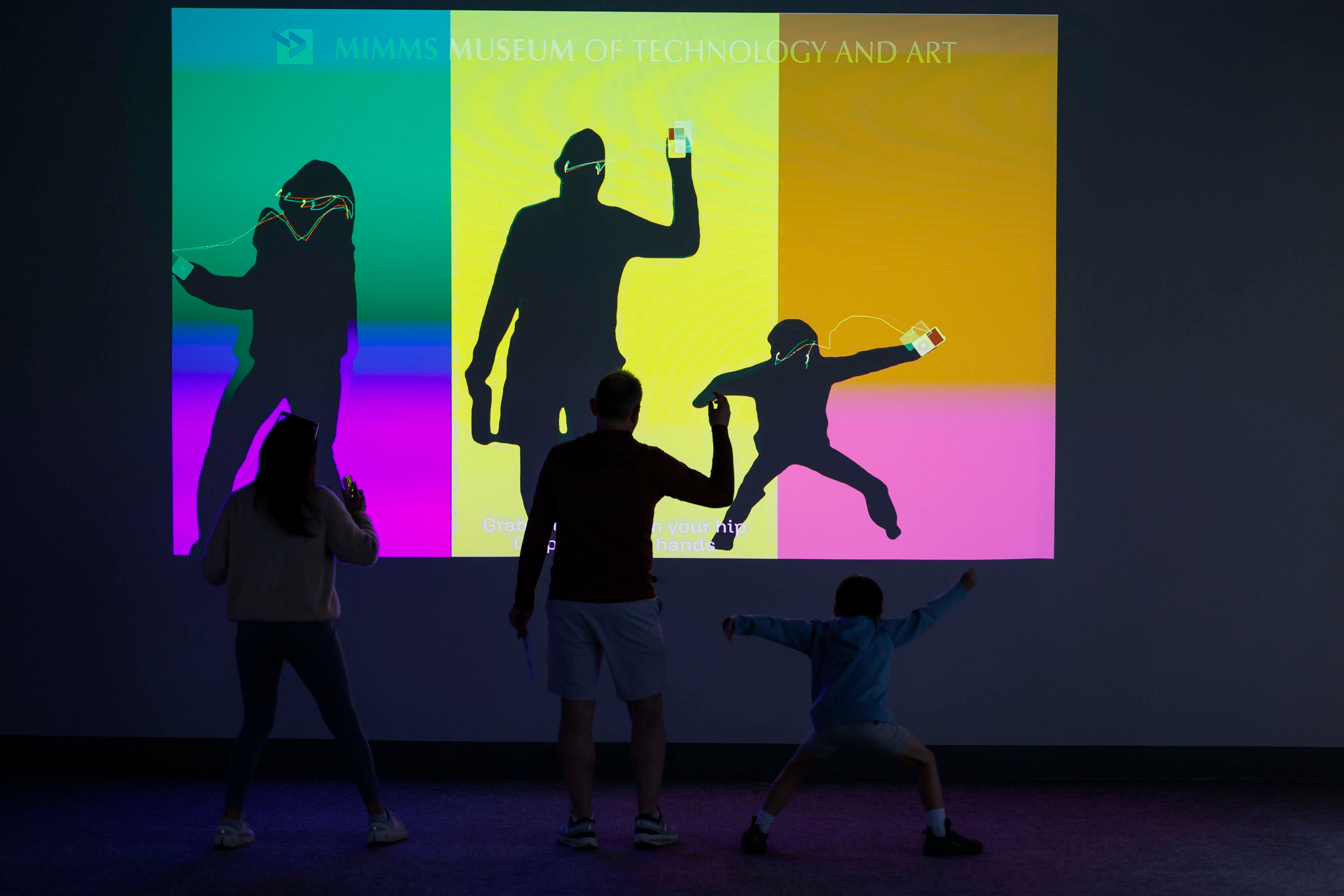A family plays with an interactive iPod screen at the "50 Years of Innovation from Apple" exhibit at the Mimms Museum in Roswell on Sunday, April 19, 2026.
(Miguel Martinez/AJC)