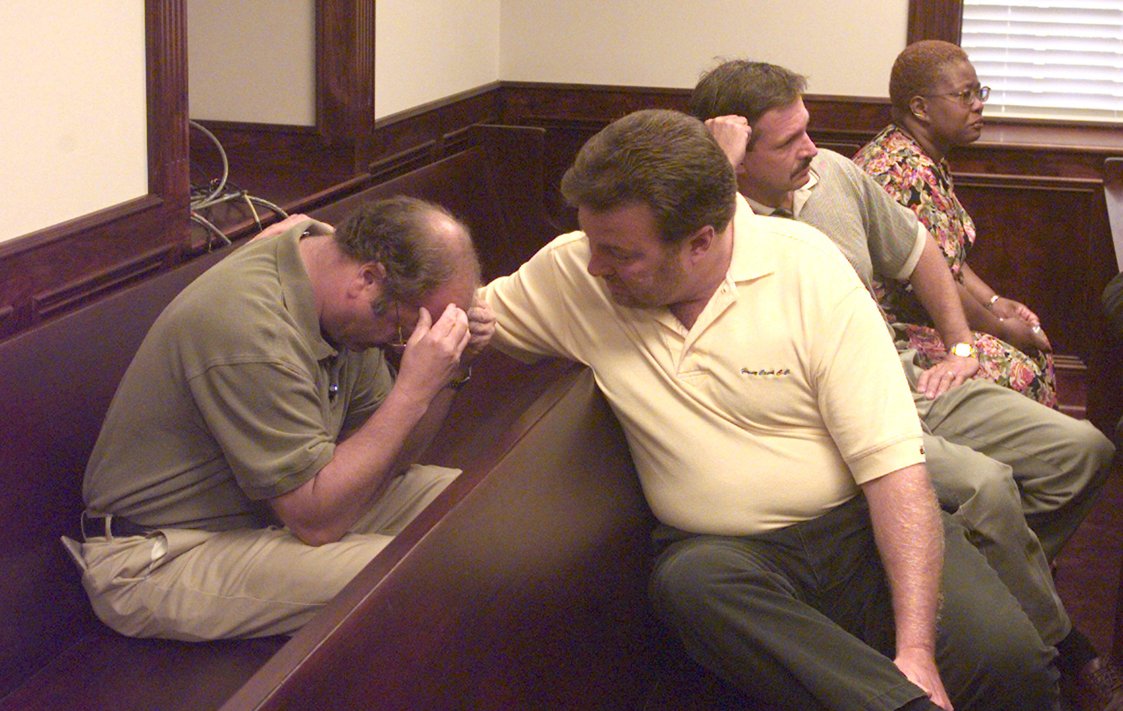 August 1999 -- A grief-stricken Steve Laster is comforted after his daughter, Stephanie, testified during a transfer hearing for T.J. Solomon. Stephanie Laster, 15 at the time, was shot in the hip when Solomon, then also 15, opened fire May 20 in the commons area of Heritage High School in Conyers.