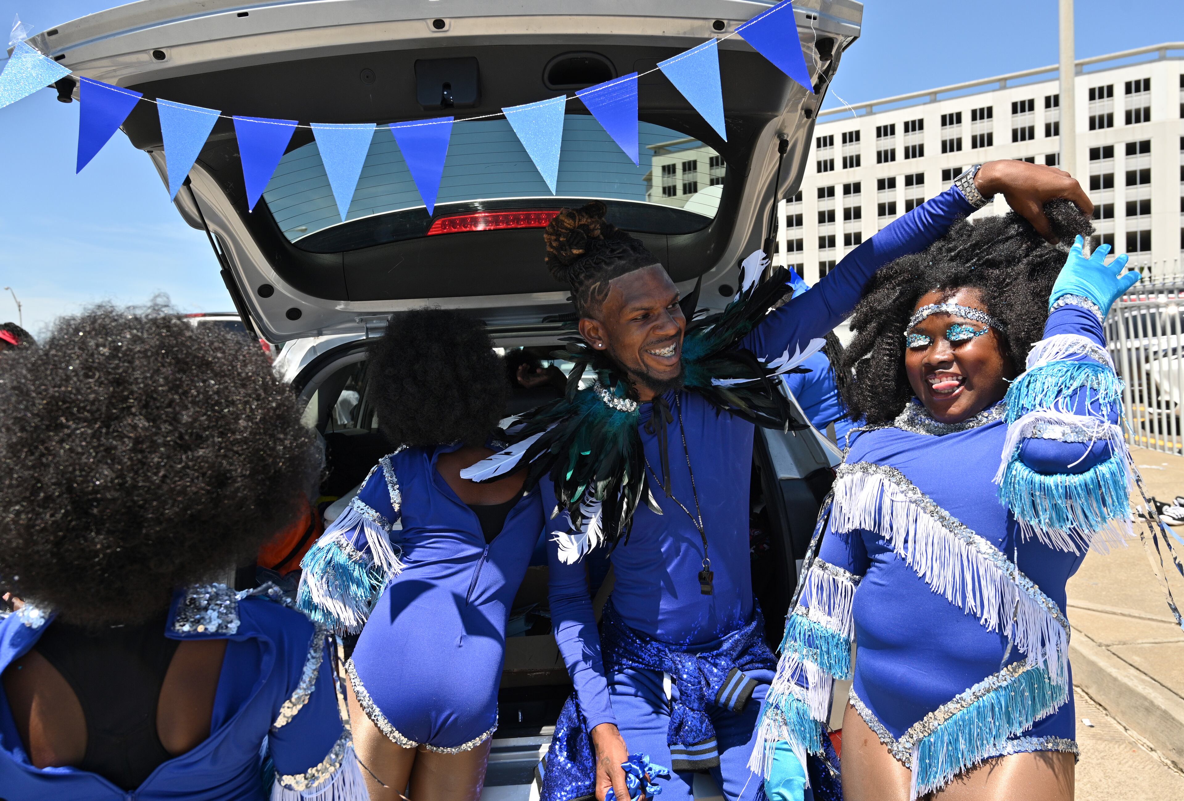 Maurice Anderson, founder of Royal Gentz Drumline, helps his dances getting ready near the Liberty plaza before the start of the Juneteenth Atlanta Black History Parade on Saturday, June 18, 2022. (Hyosub Shin / Hyosub.Shin@ajc.com)