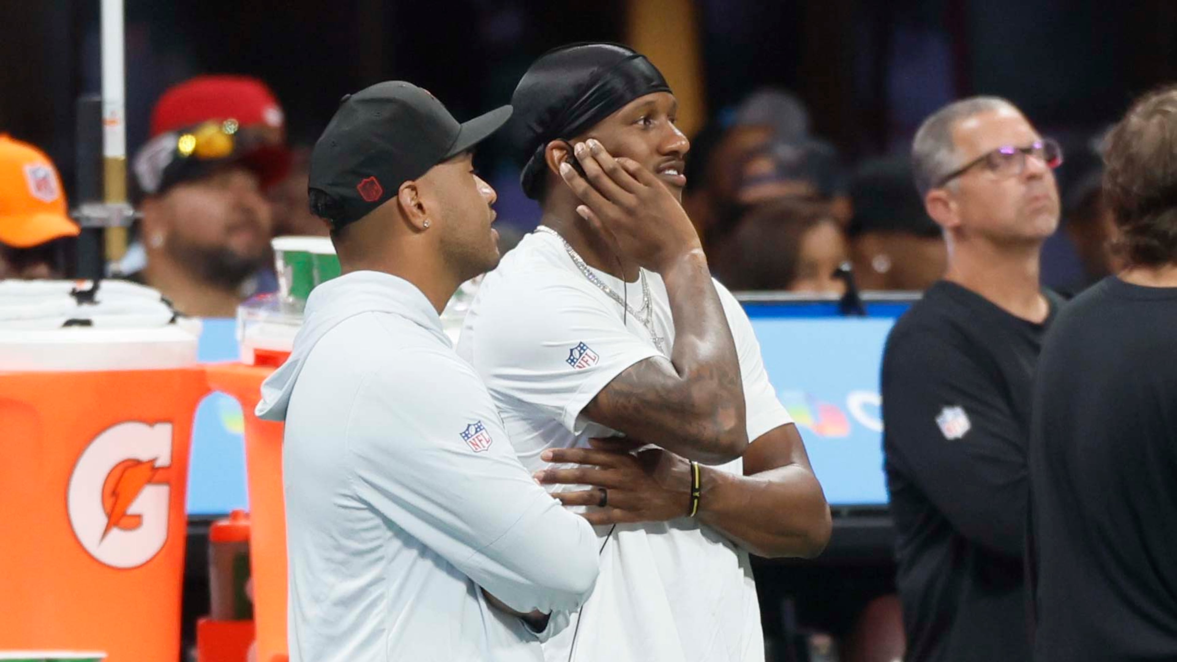 Atlanta Falcons quarterbacks Tua Tagovailoa (left) and Michael Penix Jr. watch from the sidelines Sunday. One of them might start Thursday night's game against the Green Bay Packers. (Miguel Martinez/AJC)