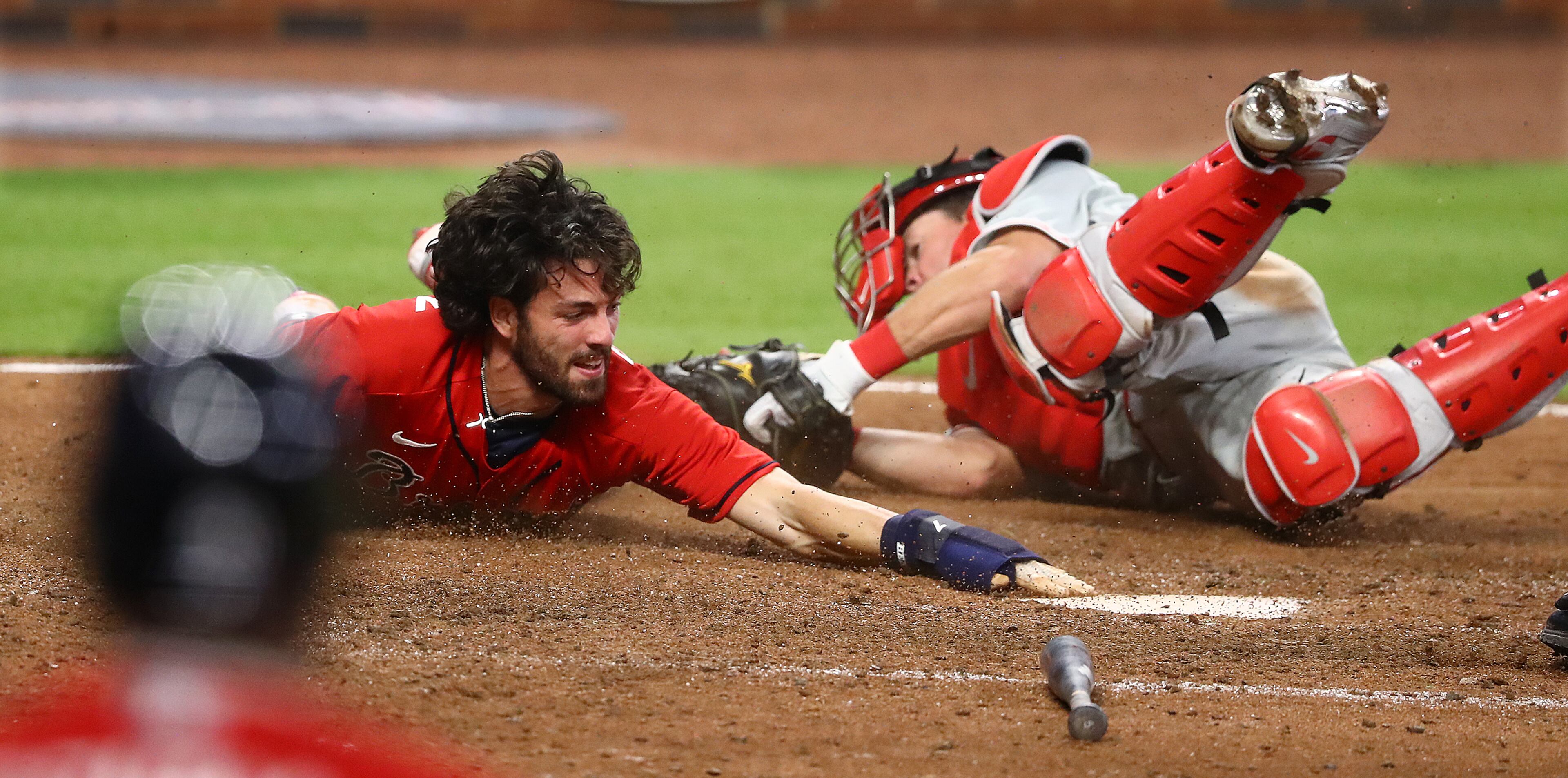 Atlanta Braves' Dansby Swanson dives home around Philadelphia Phillies catcher Andrew Knapp during the ninth inning in a MLB baseball game on Sunday, August 23, 2020 in Atlanta. Swanson was called out after a challenge on the tag stood to end the game 5-4. Curtis Compton ccompton@ajc.com