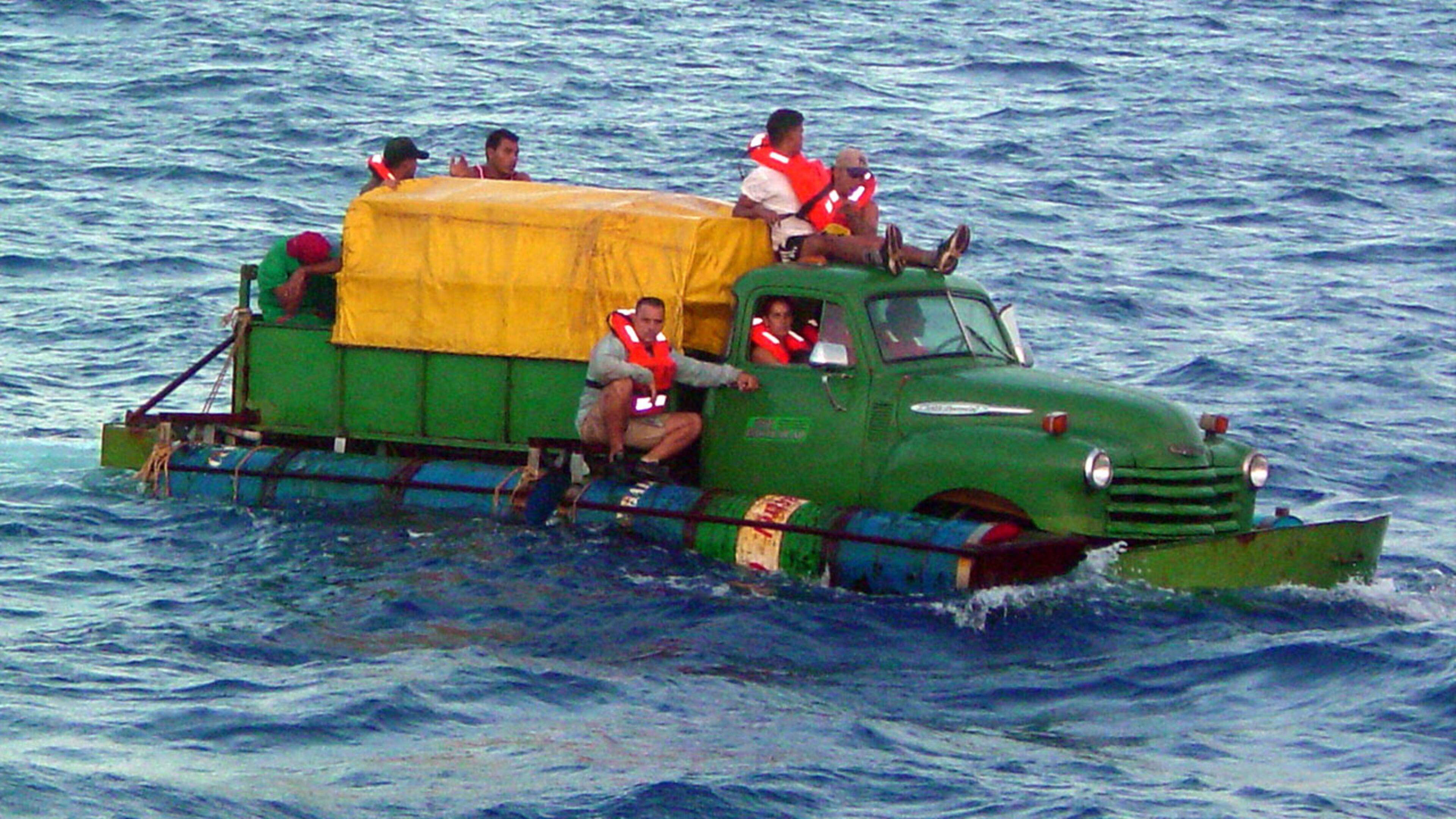 In this U.S. Coast Guard handout, Cuban migrants trying to reach the U.S. coast in Florida ride a makeshift boat made out of a 1951 Chevrolet truck with a propeller driven off the drive shaft July 16, 2003 off the coast of Florida. The U.S. Coast Guard Cutter Key Largo returned the12 Cuban migrants from the vessel back to Cuba after making it within 40 miles of Key West, Florida. The photograph was released a week after the crew was repatriated.