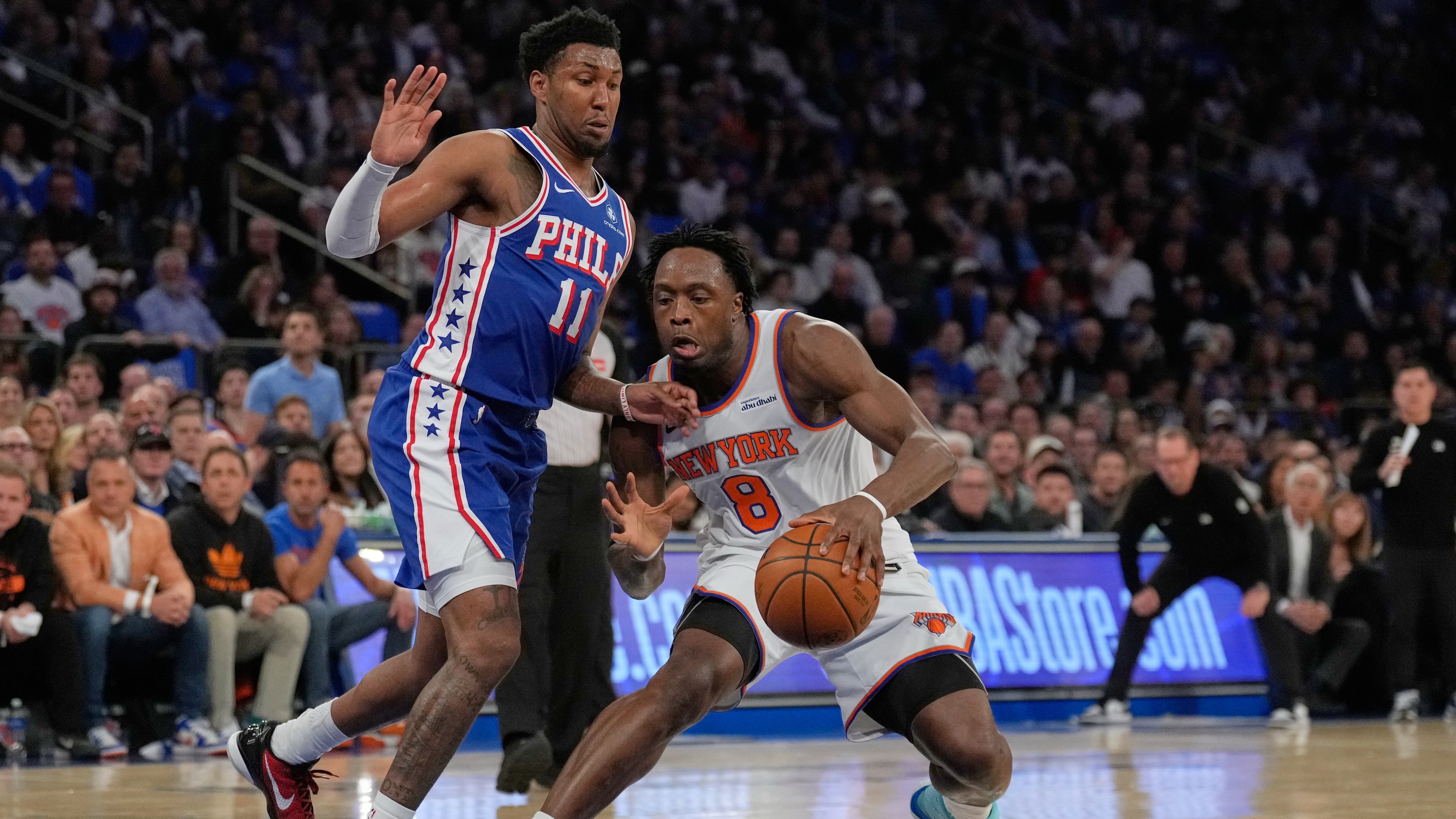 New York Knicks' Og Anunoby, right, drives past Philadelphia 76ers' Justin Edwards during the first half of Game 1 in a second-round NBA basketball playoffs series Monday, May 4, 2026, in New York. (AP Photo/Seth Wenig)