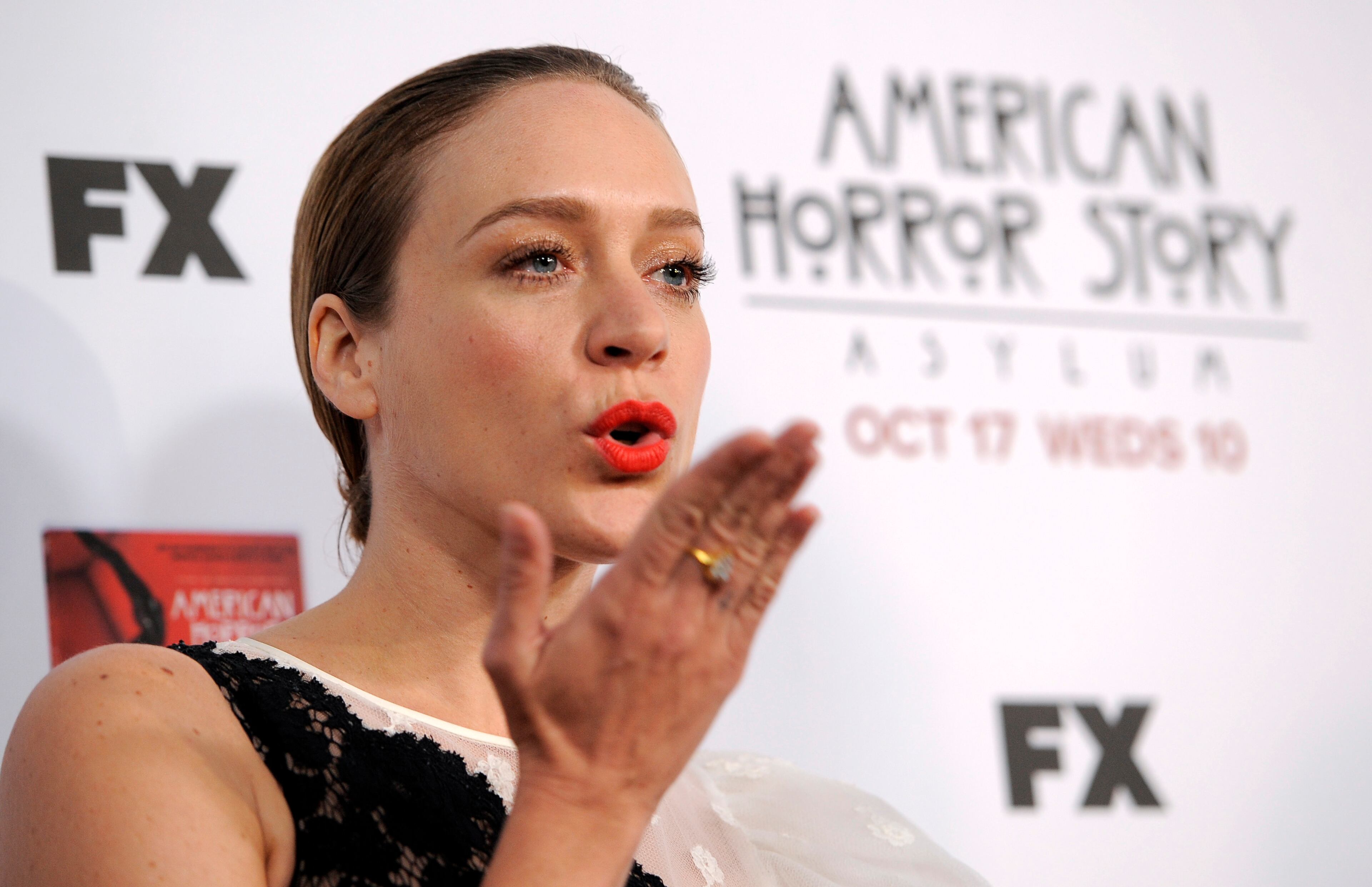 Chloe Sevigny, a cast member in "American Horror Story: Asylum," blows a kiss to photographers at the premiere screening of the television series at Paramount Theatre on Saturday, Oct. 13, 2012, in Los Angeles.