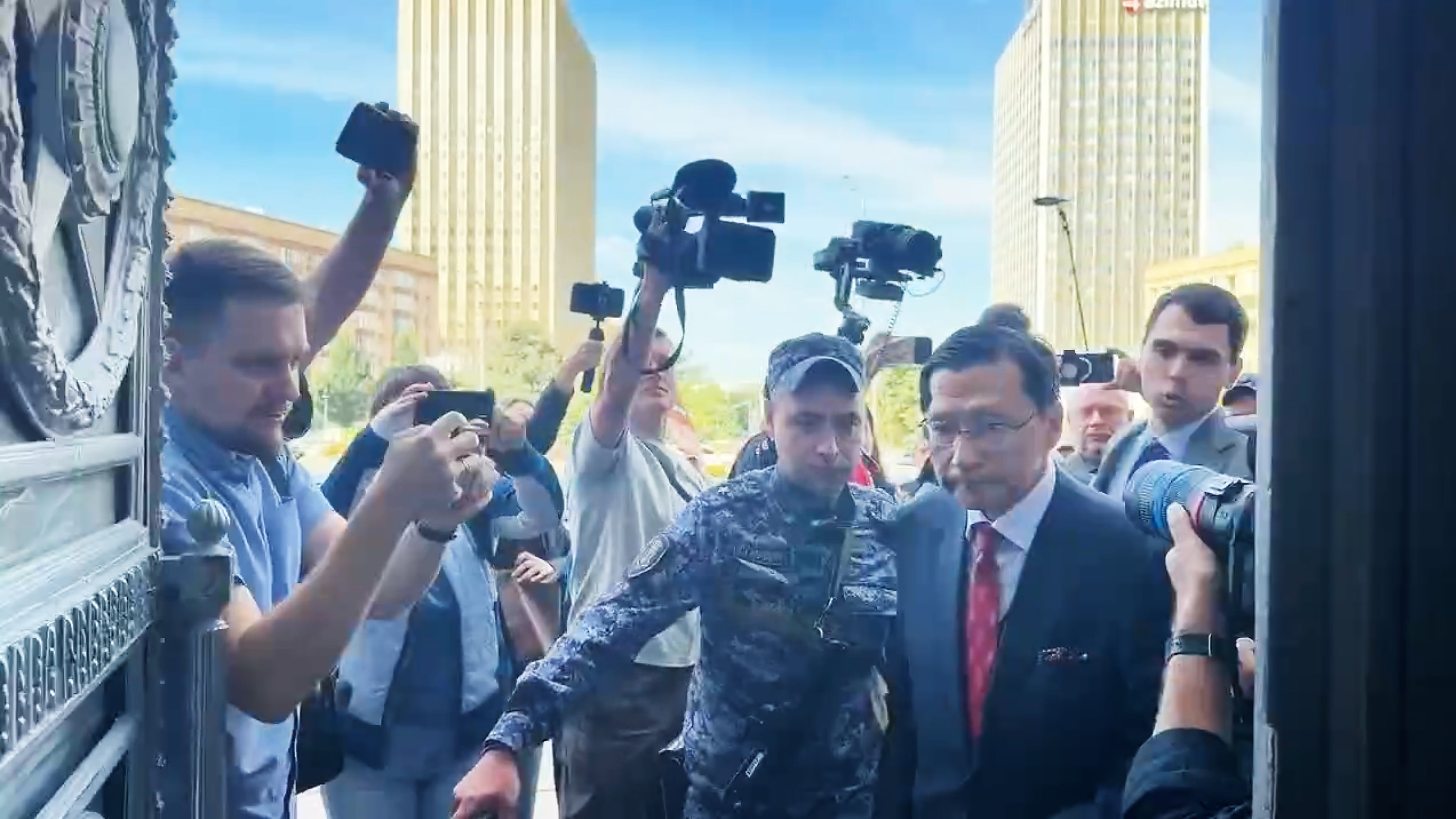 In this photo, taken from video and released by Russian Foreign Ministry Press Service, Japan's Ambassador to Russia Akira Muto, front right, enters the Russian Foreign Ministry building in Moscow, Russia, Tuesday, Aug. 18, 2026. (Russian Foreign Ministry Press Service via AP)
