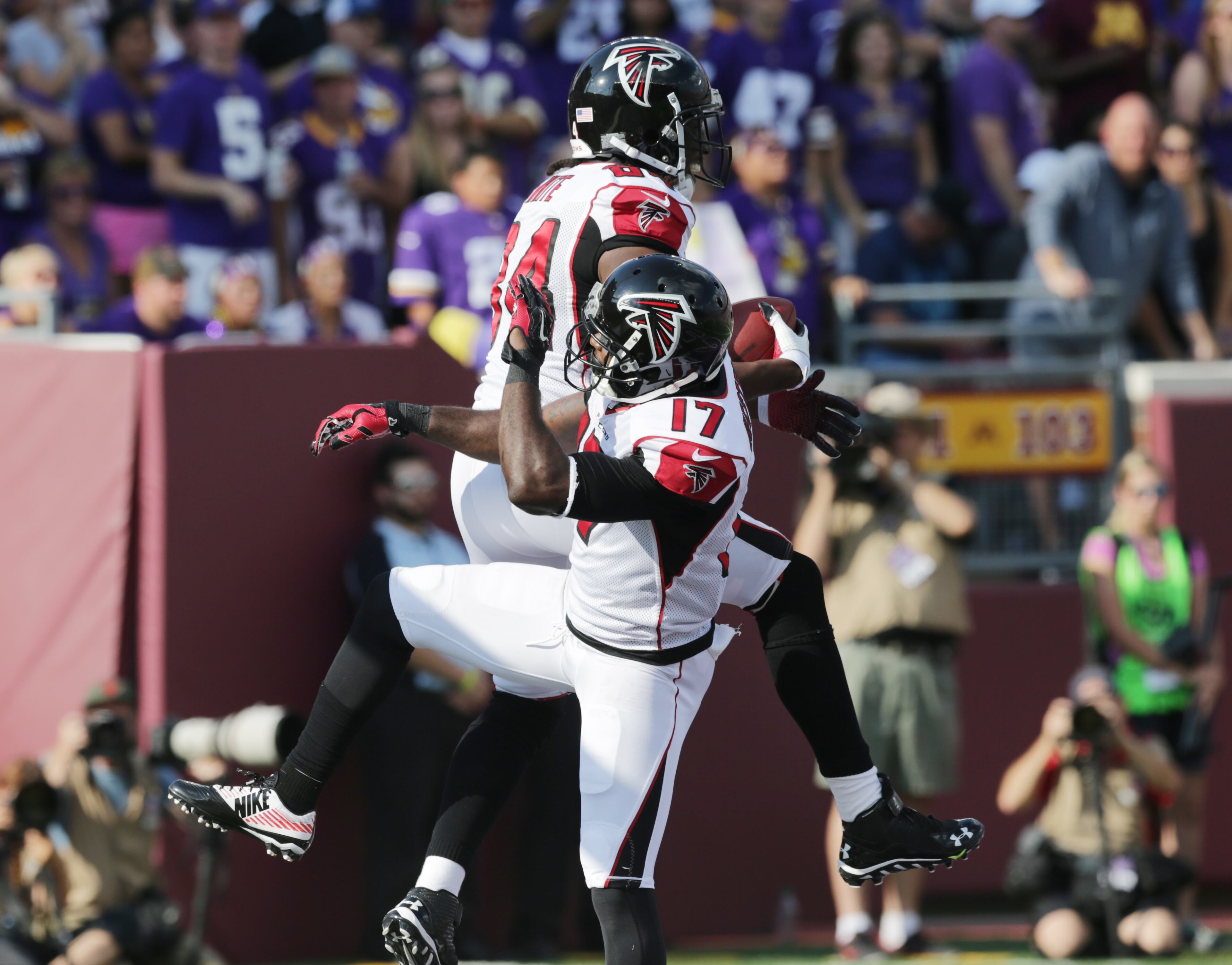 Atlanta Falcons wide receiver Roddy White (84) reacts with teammate Devin Hester (17) after catching a 24-yard touchdown pass during the first half of an NFL football game against the Minnesota Vikings, Sunday, Sept. 28, 2014, in Minneapolis. (AP Photo/Jim Mone)