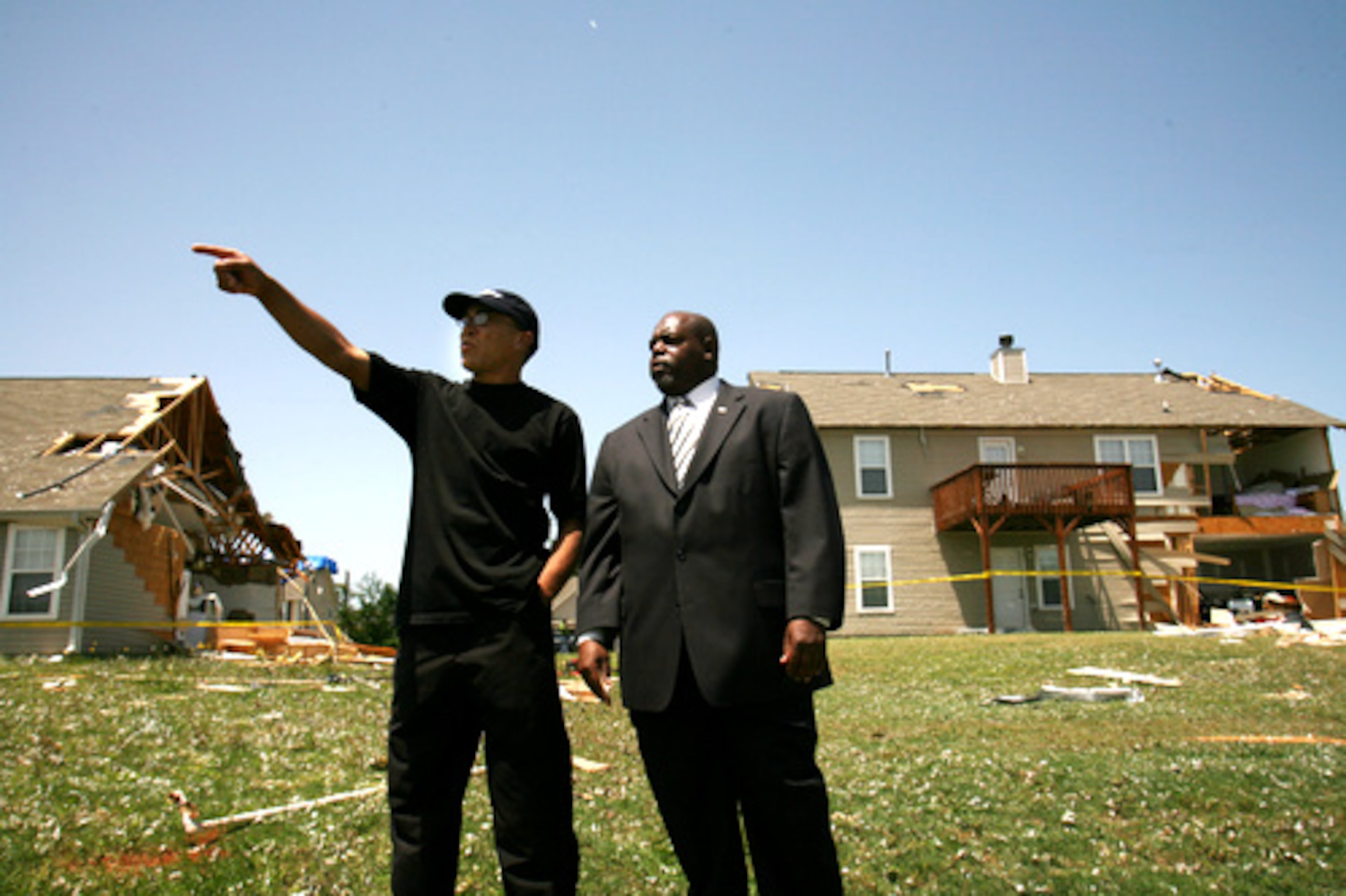 Roscoe Cox (left) shows Georgia State Rep. Mike Glanton damaged houses on Stagecoach Pass in the subdivision.