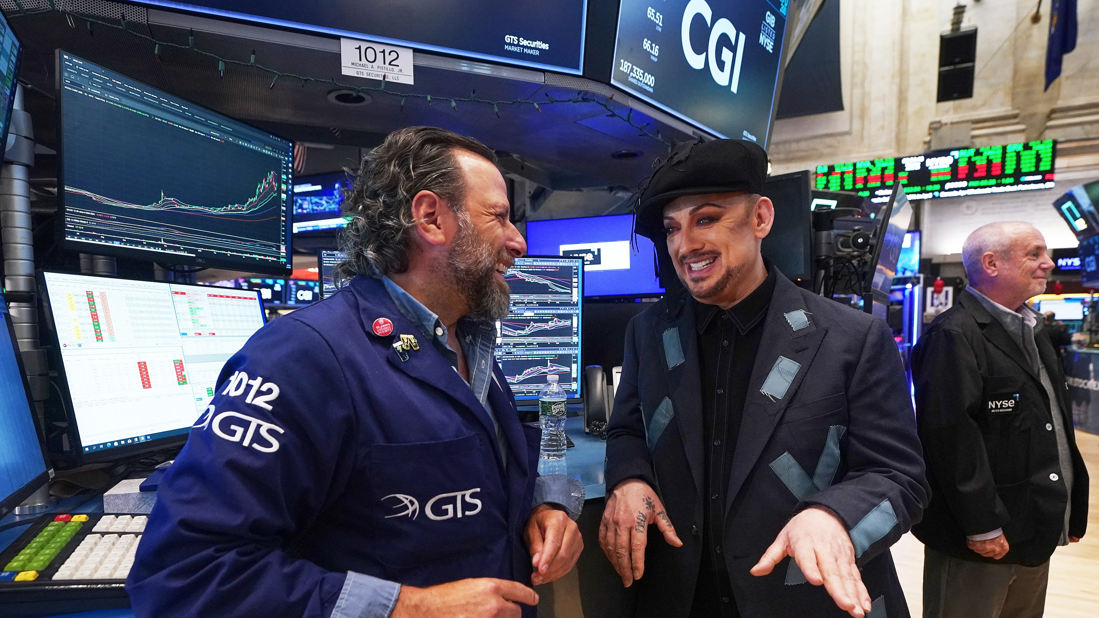 Singer Boy George, right, who is re-releasing "Karma Chameleon," talks with specialist Michael Pistillo during his visit to the floor of the New York Stock Exchange, Monday, June 15, 2026. (AP Photo/Richard Drew)
