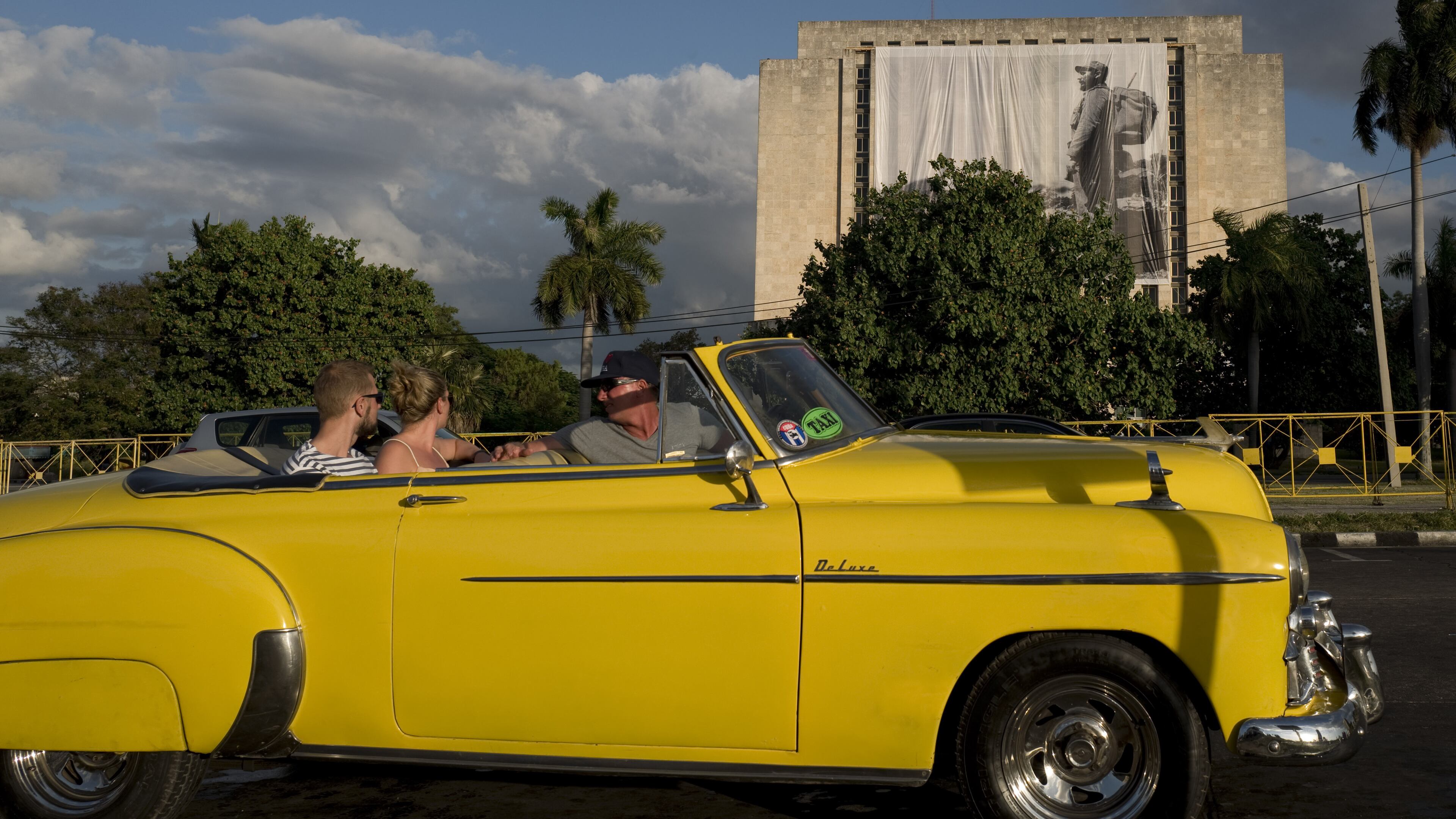 Tourists in an Oldsmobile convertible in Havana, Cuba, on Nov. 27, 2016. Bloomberg photo by Eliana Aponte.