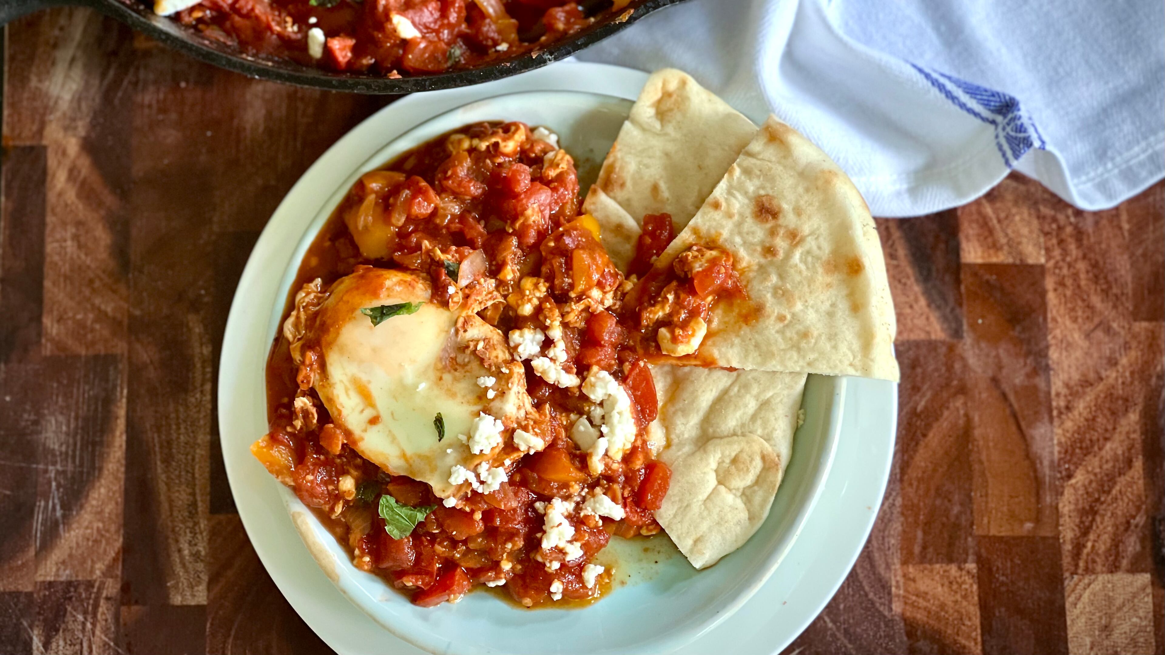Three pounds (or more!) of garden-fresh tomatoes simmer down into a delicious, bright-tasting summer shakshuka. (Kellie Hynes for The Atlanta Journal-Constitution)