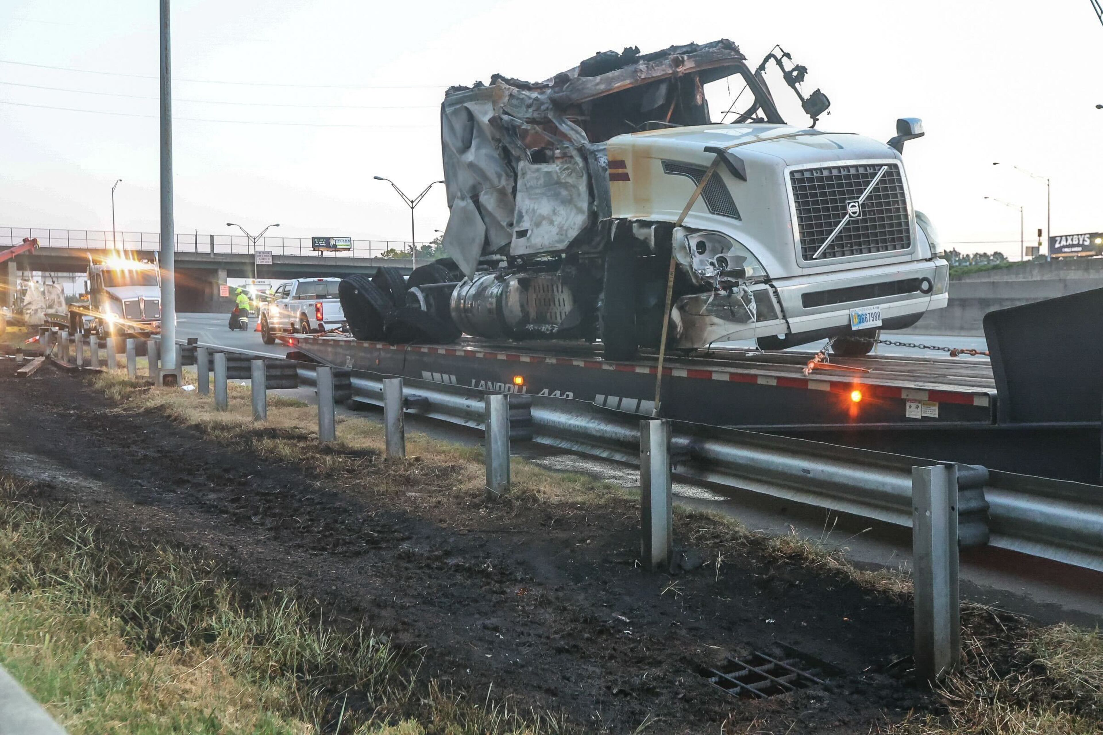 Traffic was shut down for hours on I-75 South in Cobb County after a tractor-trailer carrying barrels of brake fluid crashed and caught on fire.