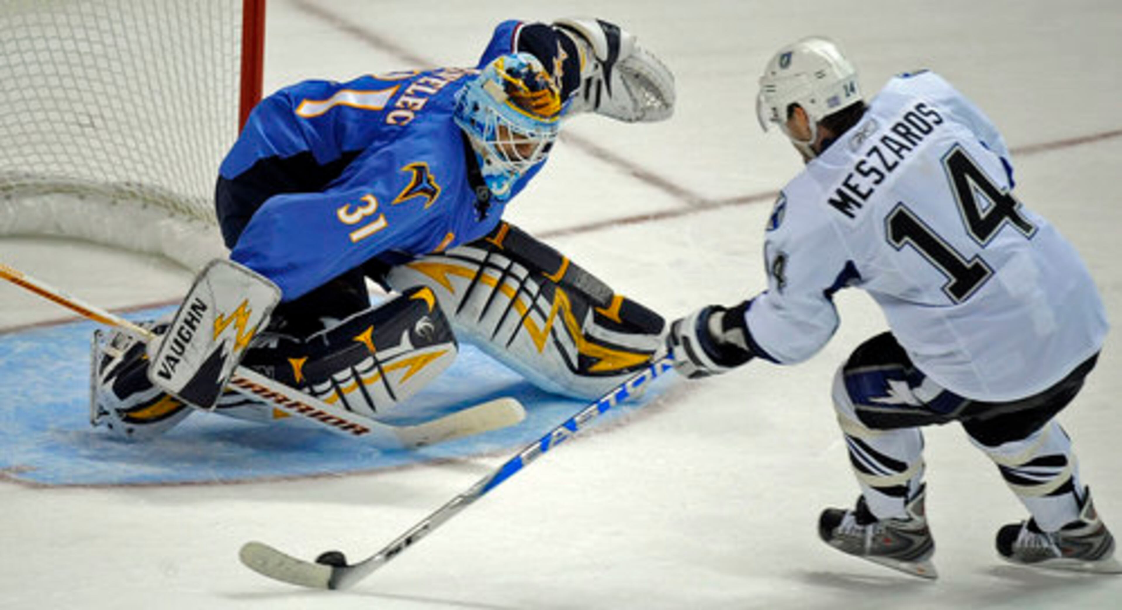 Thrashers' goaltender Ondrej Pavelec stops an attempted goal by the Lightning's Andrej Meszaros.