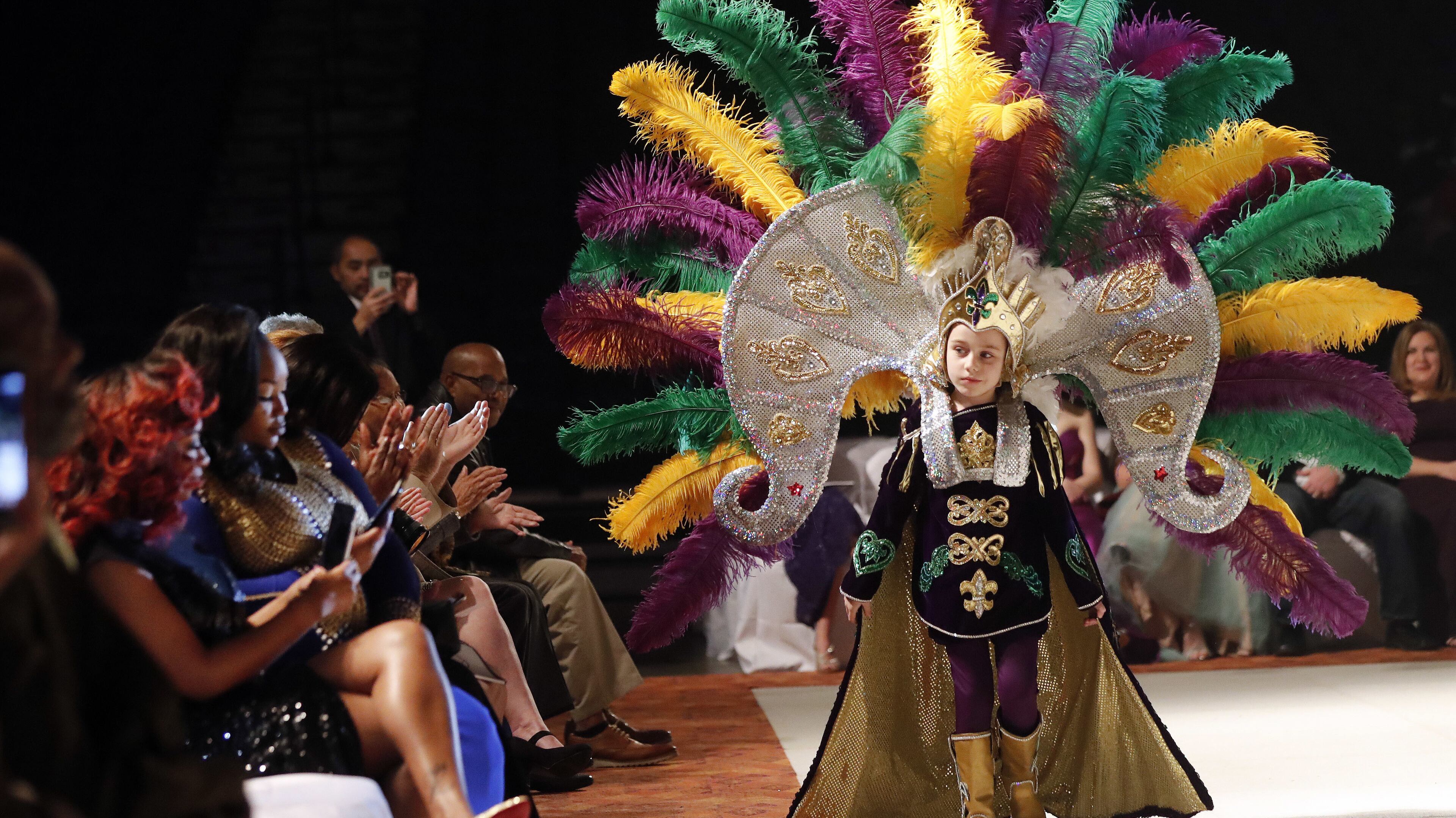 Jack Spittler III, a member of the royal court, walks for the audience at the Little Rascals Mardi Gras Ball in Kenner, La., Thursday, Jan. 25, 2018. (AP Photo/Gerald Herbert)