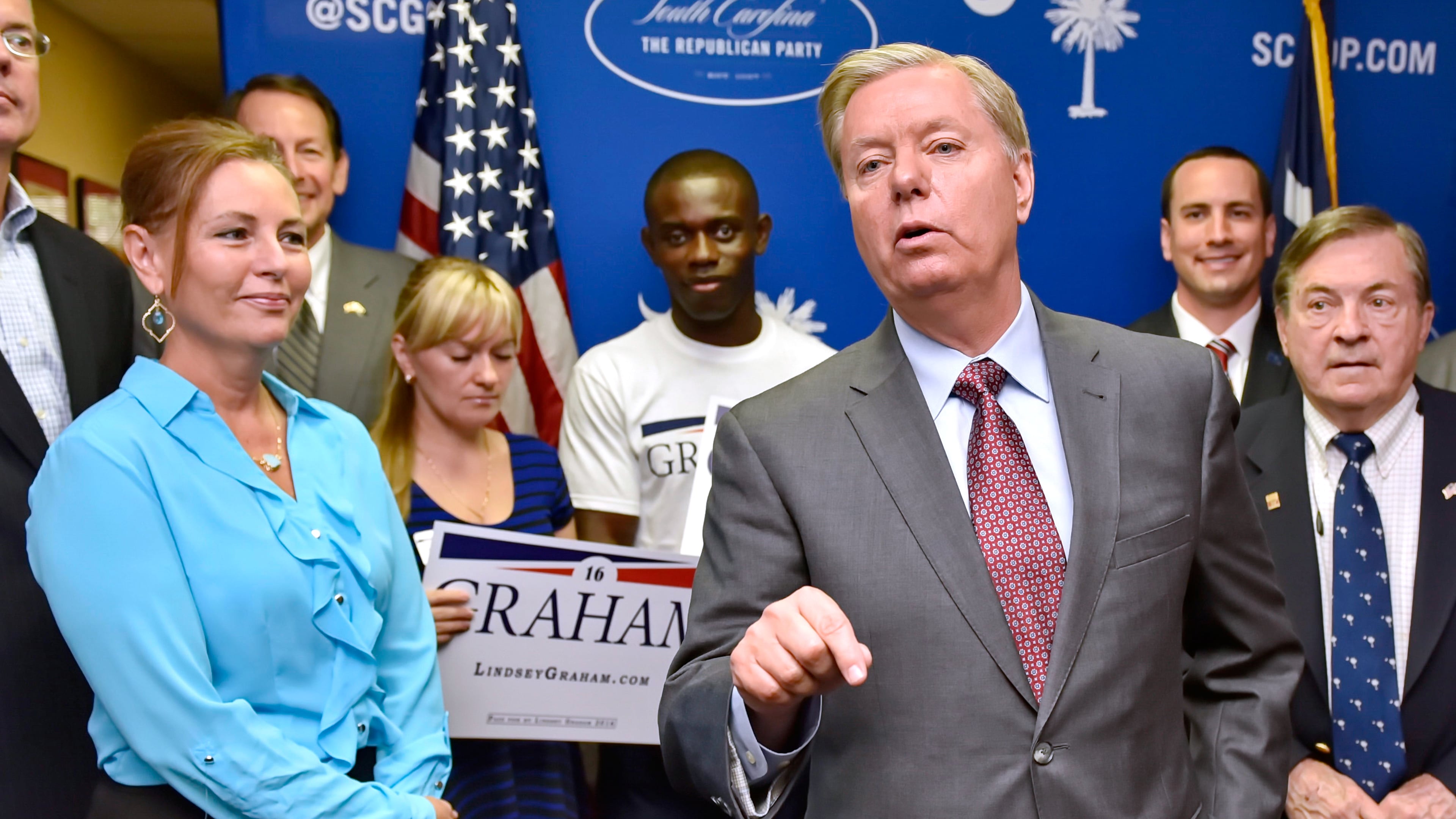 FILE - Republican presidential candidate, Sen. Lindsey Graham, R-S.C., accompanied by his sister Darline, left, speaks at the GOP headquarters in Columbia, S.C., Sept. 1, 2015, where he filed for the South Carolina Presidential Primary. (AP Photo/Richard Shiro, File)