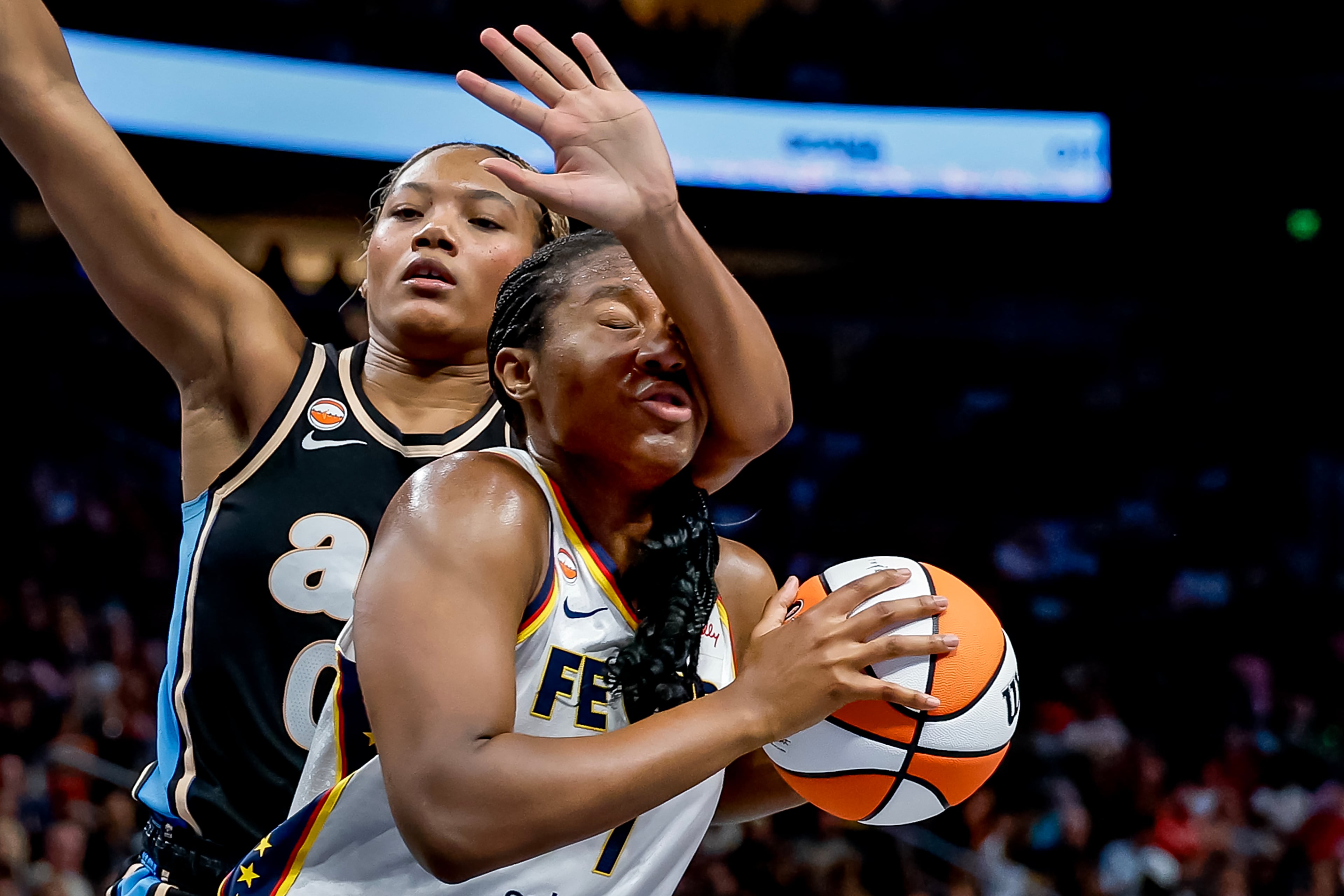 Indiana Fever center Michelle Onyiah (right) is defended by Atlanta Dream forward Naz Hillmon. (Erik S. Lesser for the AJC)