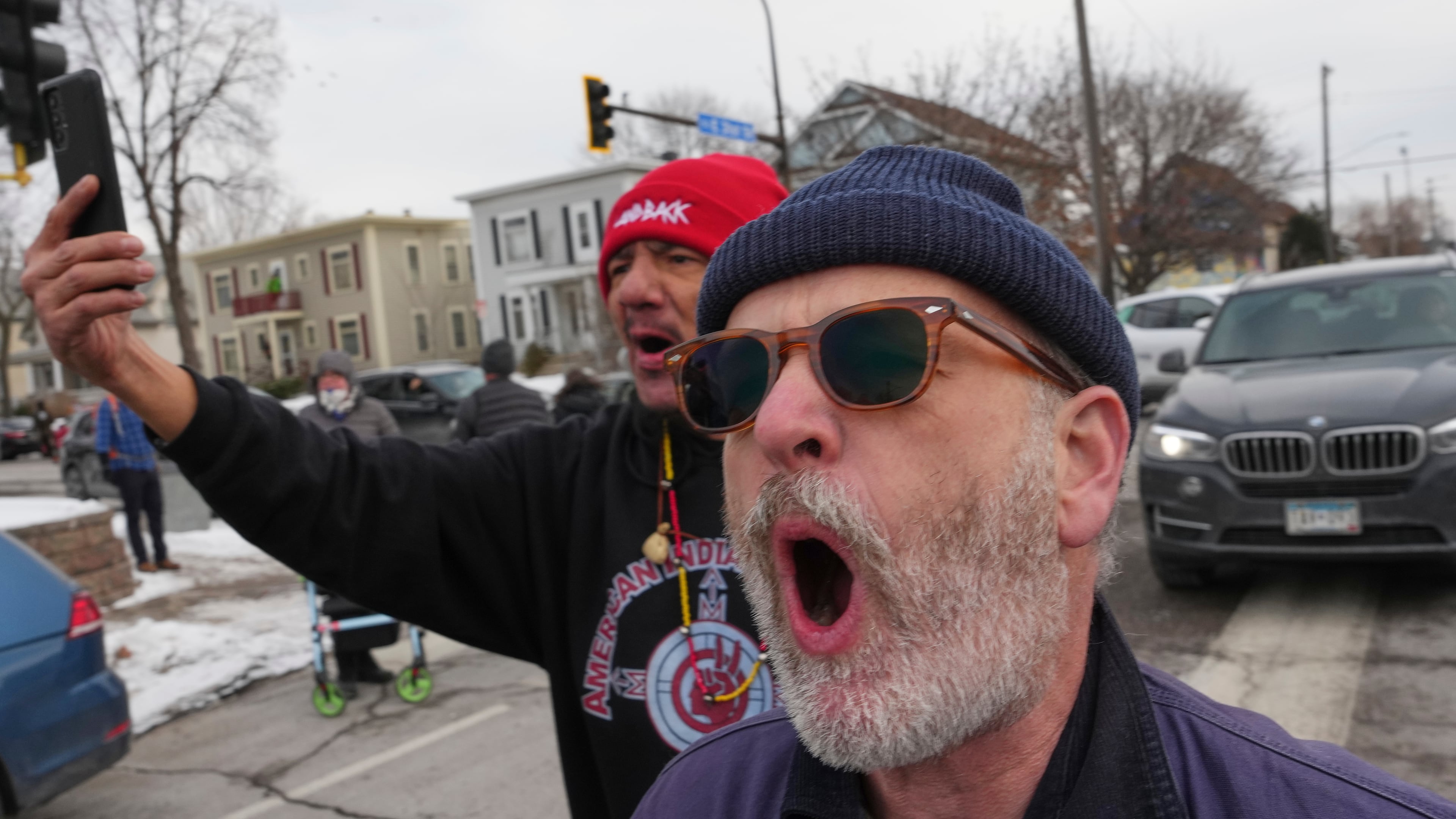 People shout toward Border Patrol agents making an arrest, Sunday, Jan. 11, 2026, in Minneapolis. (AP Photo/Adam Gray)