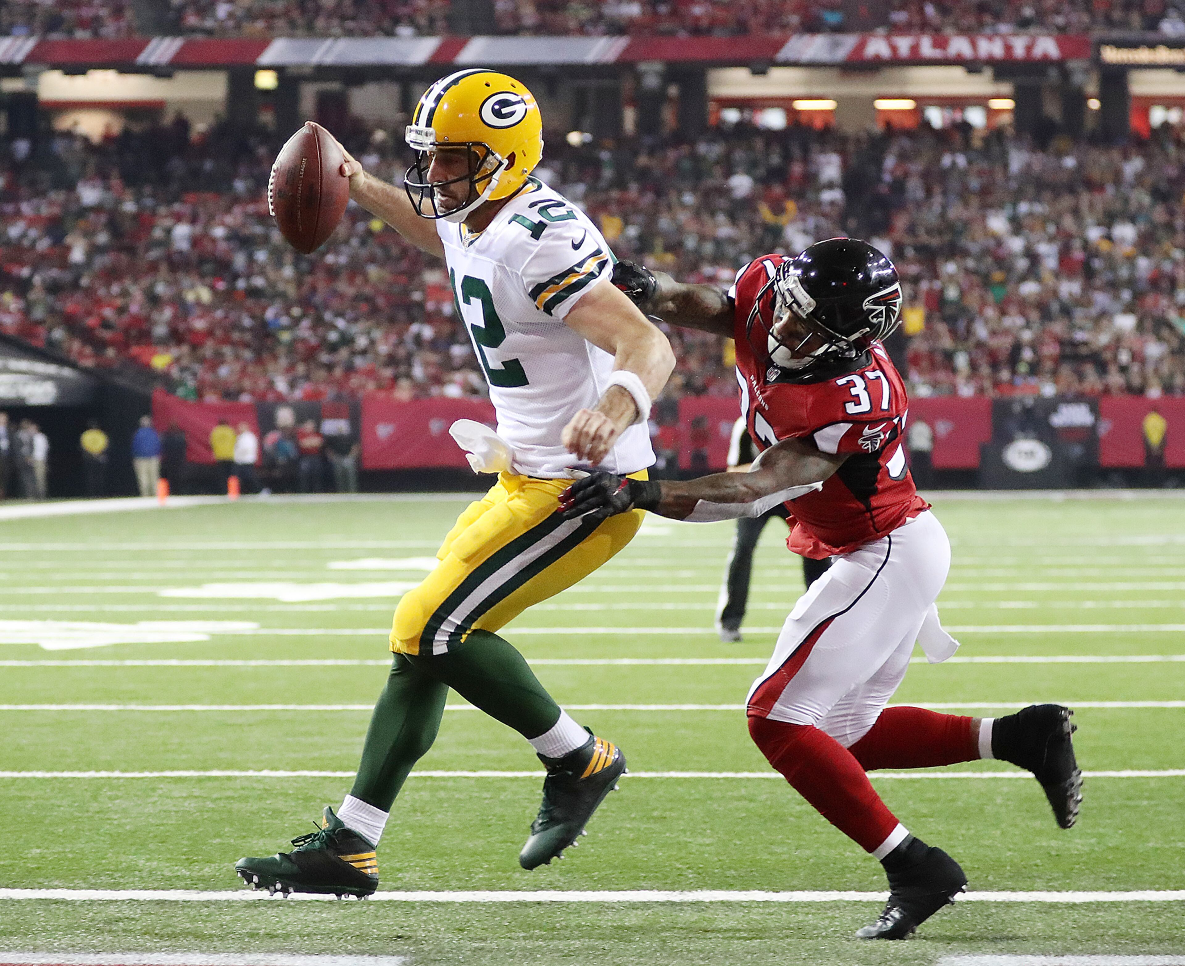 October 30, 2016 ATLANTA: Packers quarterback Aaron Rodgers gets into the endzone on a quarterback keeper past Falcons safety Ricardo Allen for a two-point conversion and a 32-26 lead during the fourth quarter in an NFL football game on Sunday, Oct. 30, 2016, in Atlanta. The Falcons came back for a touchdown drive of their own to win the game 33-32. Curtis Compton /ccompton@ajc.com