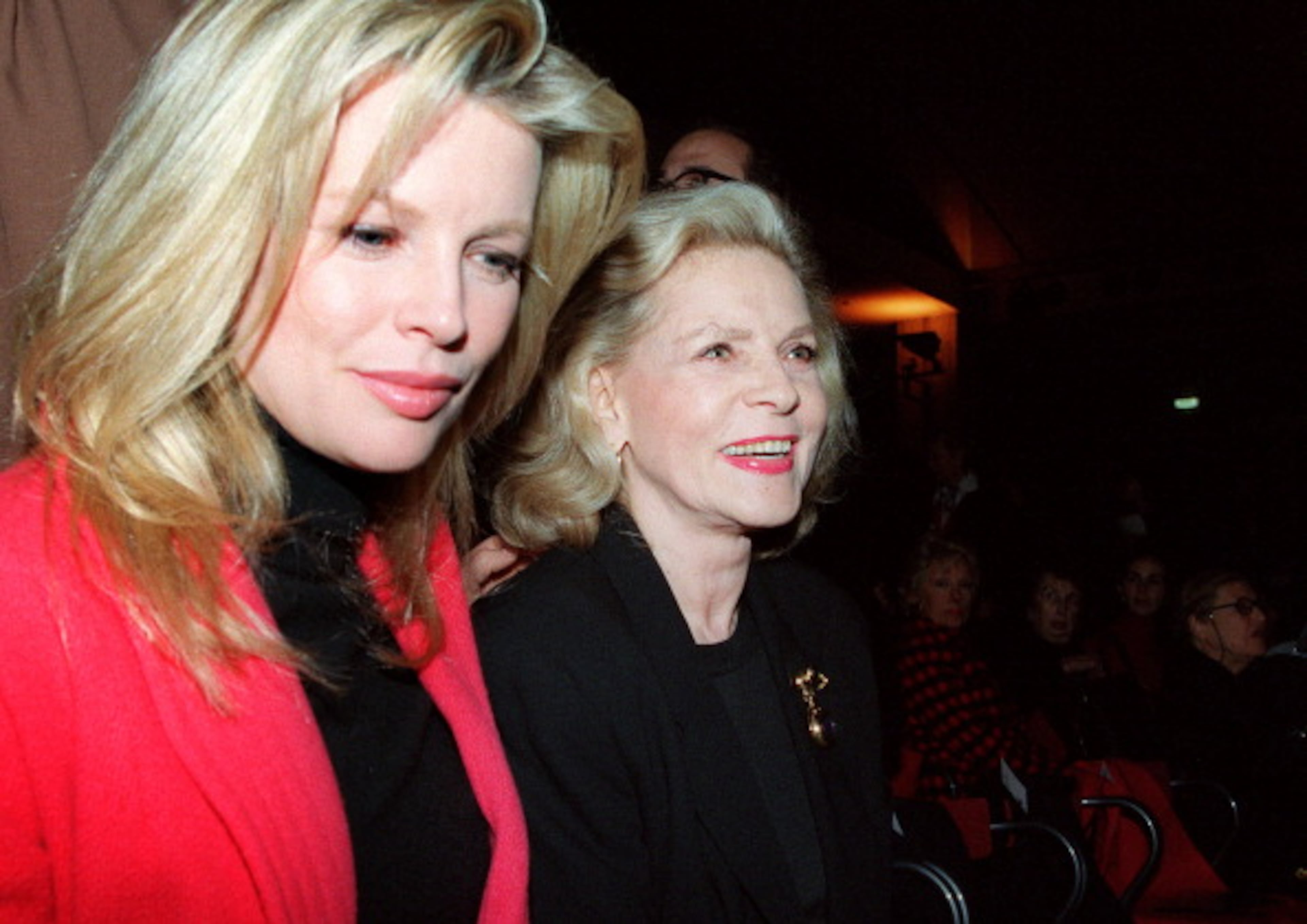 American actresses Lauren Bacall (R) and Kim Basinger watch the presentation of the Michel Klein's winter 94/95 fashion collection at the Louvre Carrousel on March 4, 1994. The two star play in Robert Altman's "Ready to wear", a film about the fashion world. AFP PHOTO PATRICK KOVARIK (Photo credit should read PATRICK KOVARIK/AFP/GettyImages)