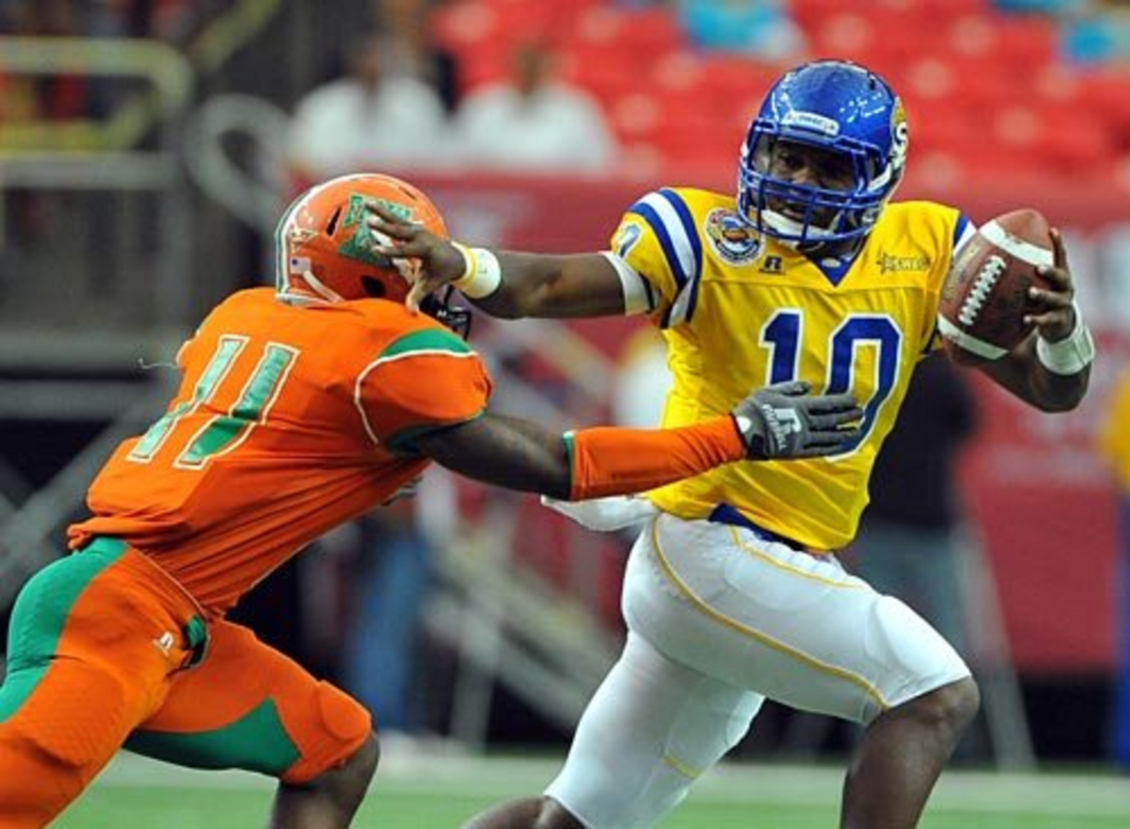 Southern University quarterback Dray Joseph stiff-arms Florida A&M University defender Demarius Folsom.