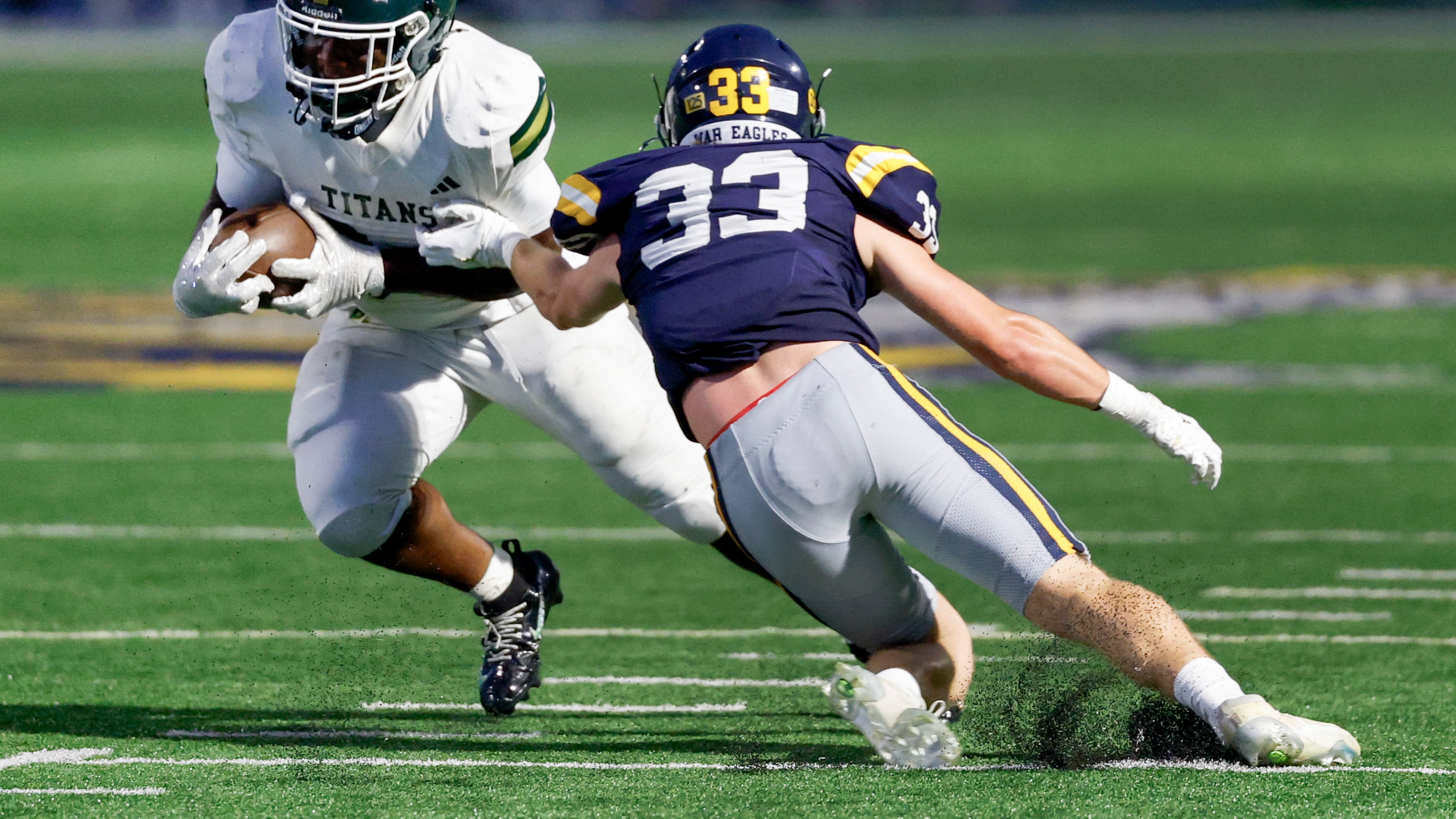 Marist linebacker Jack Weeks (right) tries to stop Blessed Trinity running back MJ Craft during a 2026 game between two of the state's strongest private schools. Most public-school football coaches who responded to an AJC Varsity survey support putting private schools like these into private-only state playoffs, preventing them from playing for state titles against public schools in all sports, as they do now. (Erik S. Lesser for the AJC)