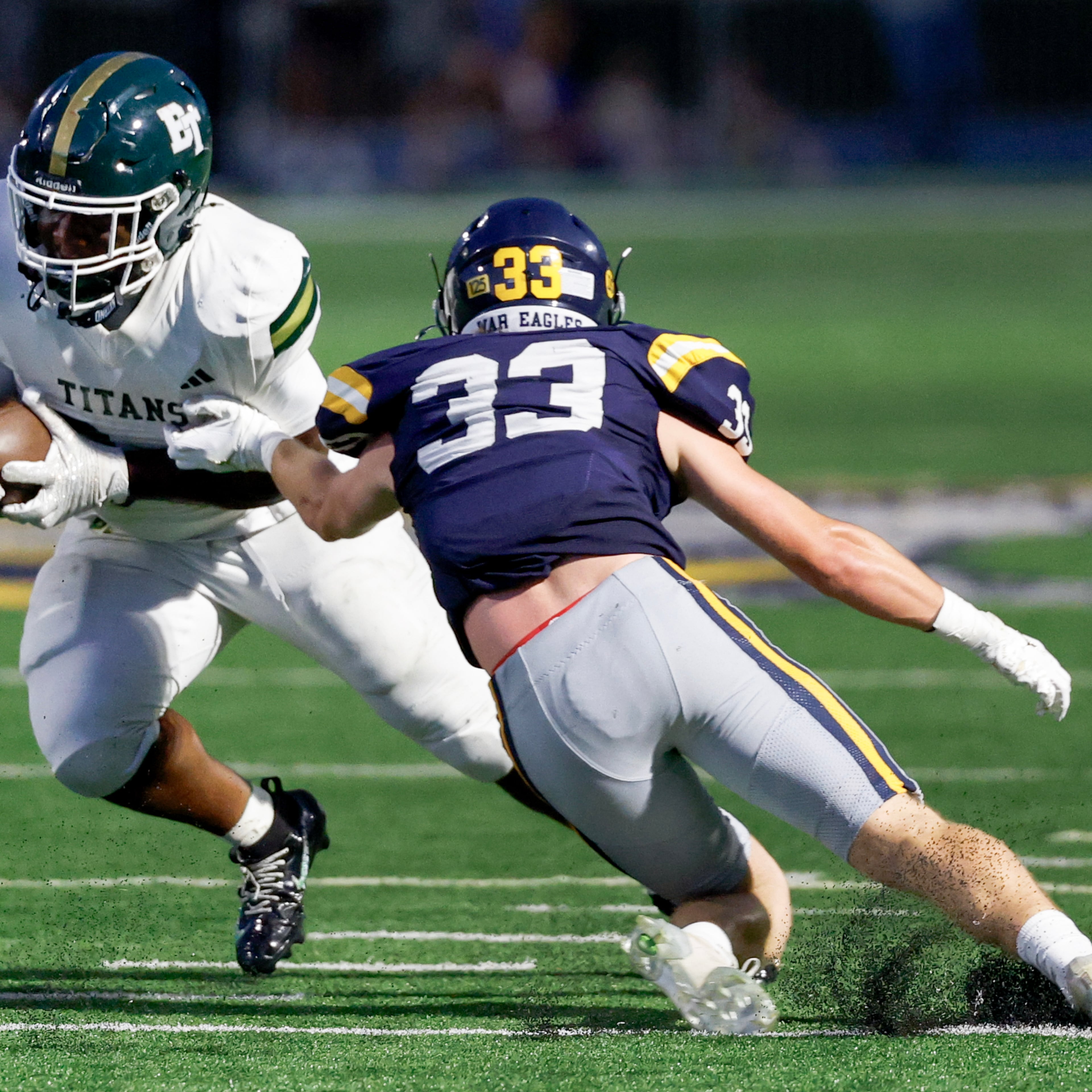 Marist linebacker Jack Weeks (right) tries to stop Blessed Trinity running back MJ Craft during a 2026 game between two of the state's strongest private schools. Most public-school football coaches who responded to an AJC Varsity survey support putting private schools like these into private-only state playoffs, preventing them from playing for state titles against public schools in all sports, as they do now. (Erik S. Lesser for the AJC)
