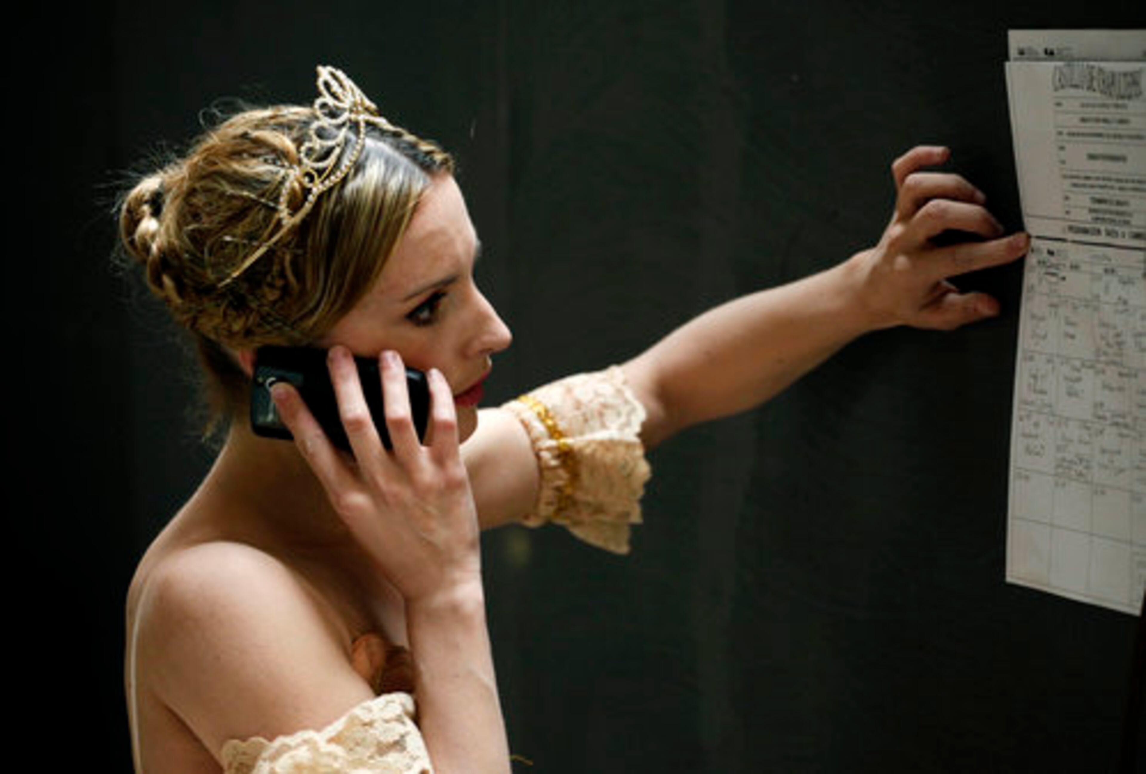 A dancer from Mexico's National Dance Company speaks on a cell phone before a dress rehearsal of Sleeping Beauty at Chapultepec Castle in Mexico City, Monday April 4, 2011.