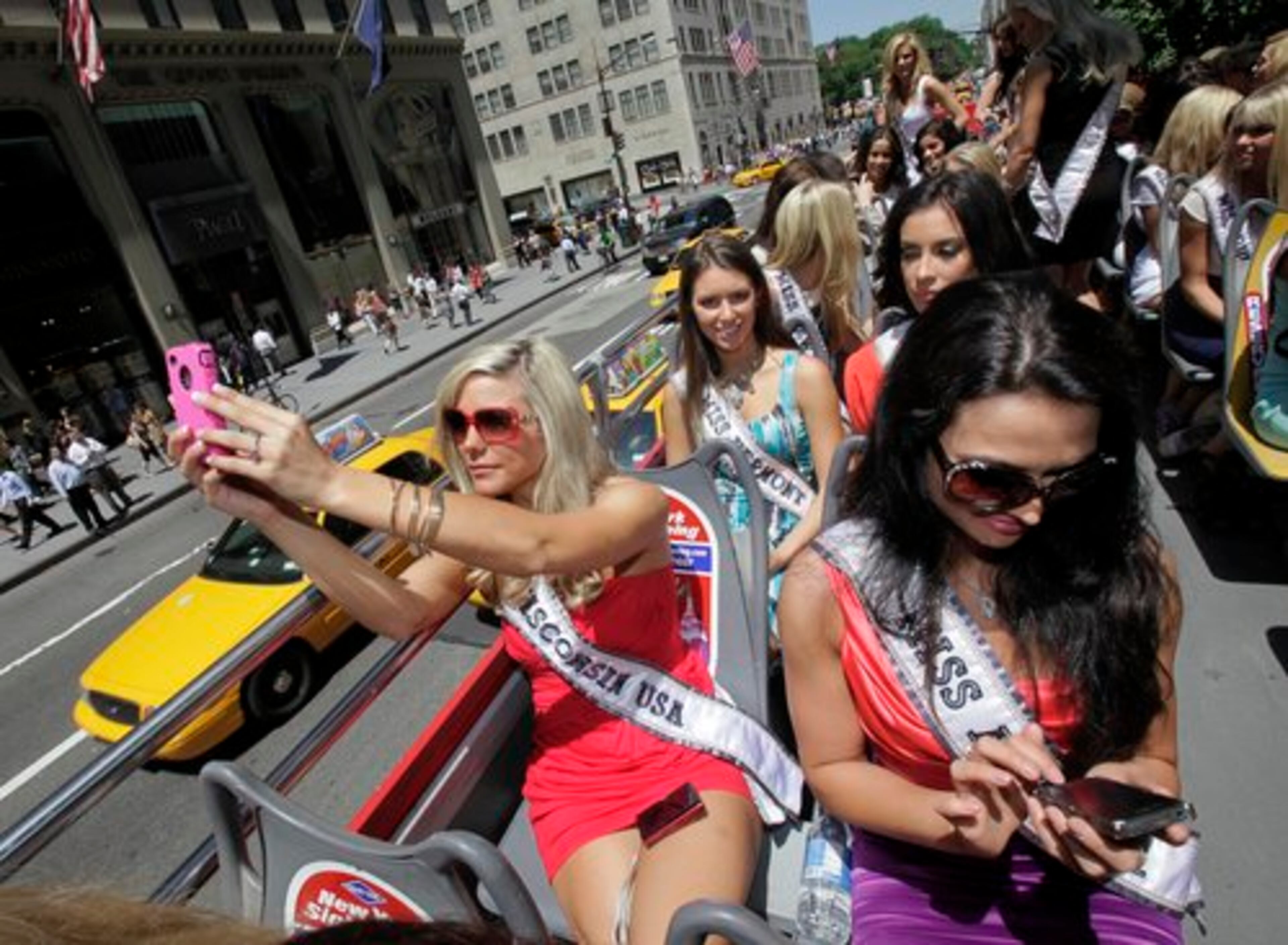 Miss Wisconsin Jordan Marie Morkin, left, and Miss Alaska Jessica Chuckran capture the moment with their camera phones.