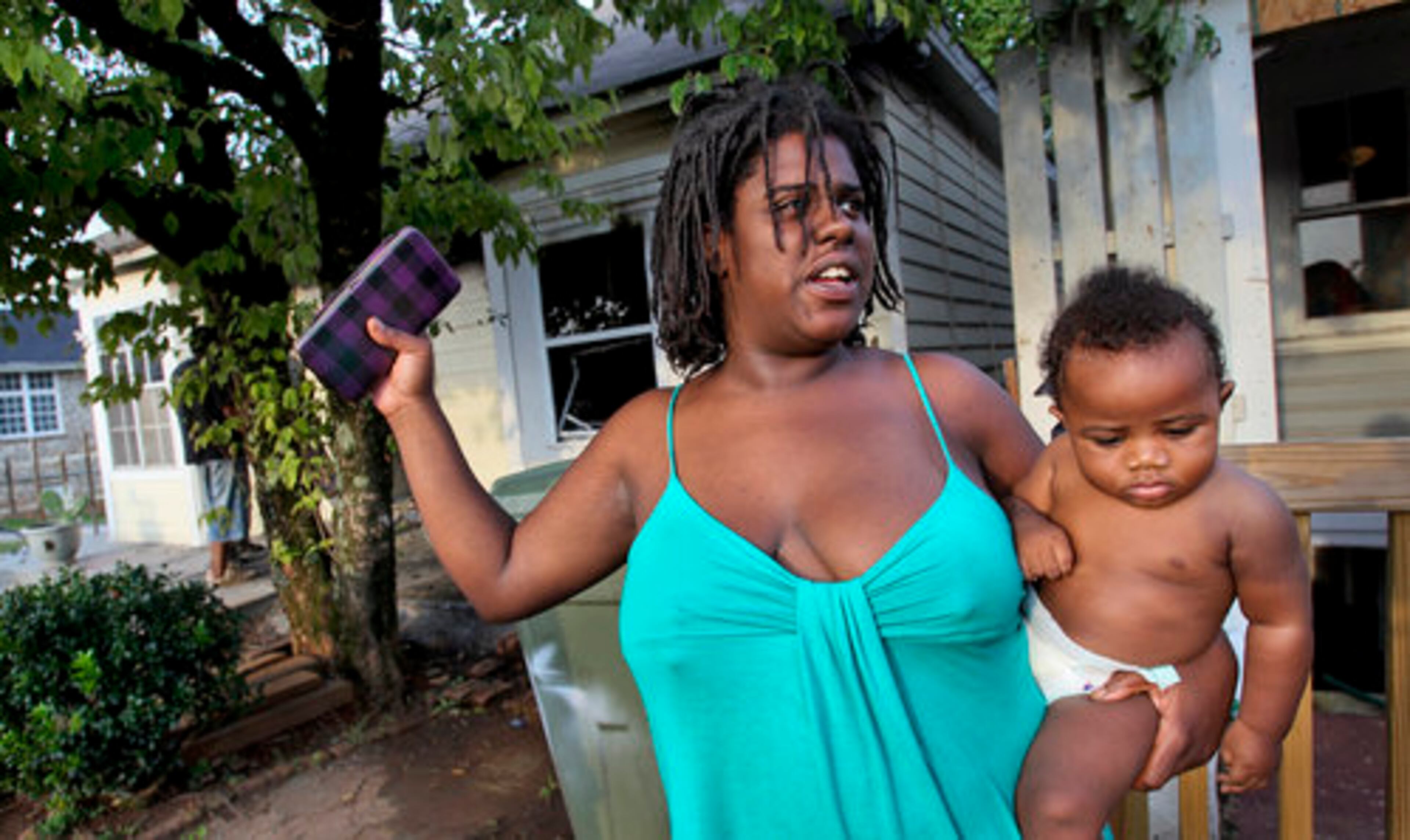 Resident, Kenya McDow holding her 8-month old son, Jimmy just made it out in time. Firefighters said said six to eight people living in the boarding house were able to make it out safely before fire crews arrived.