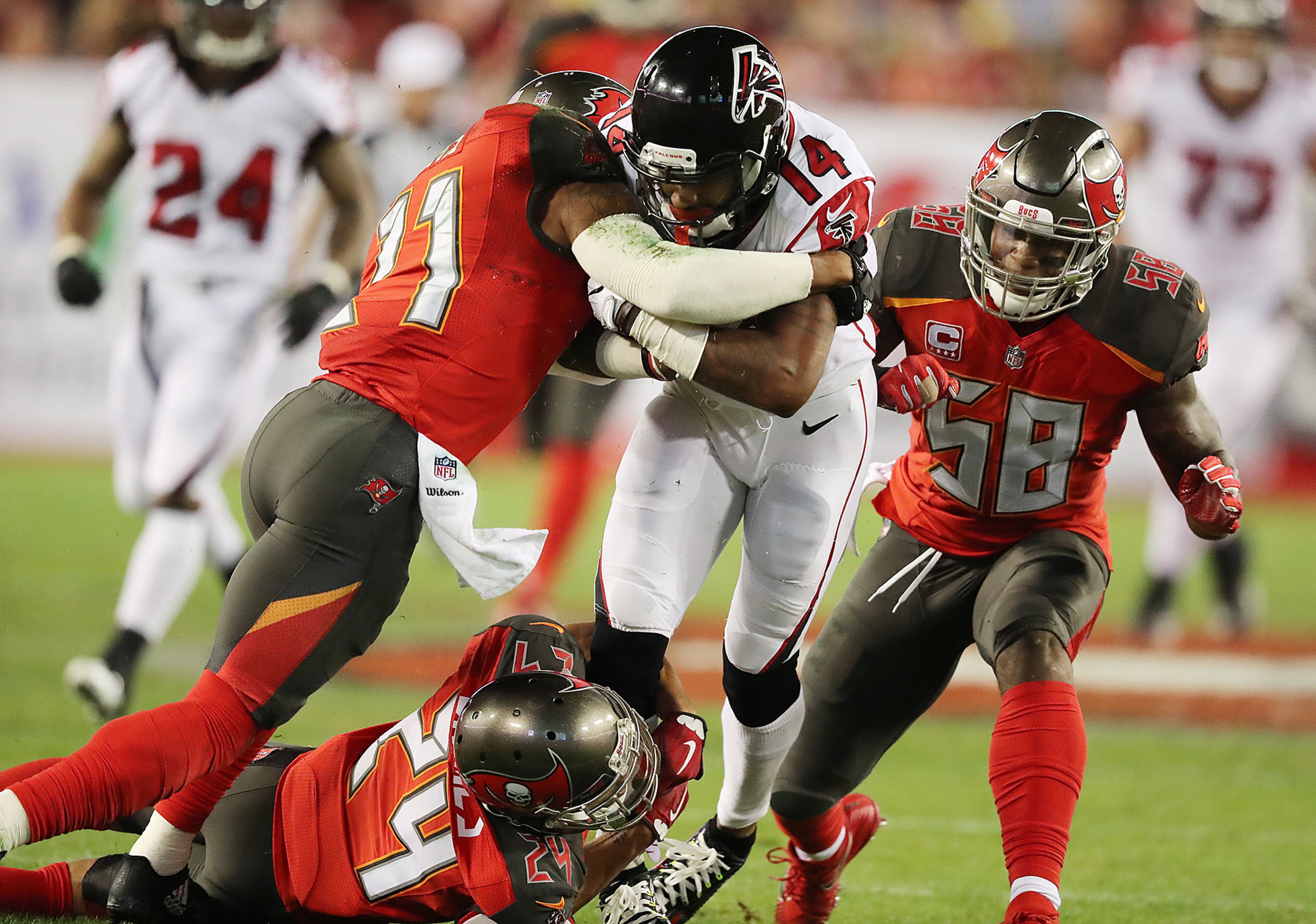 *** VISUAL LEDE *** December 18, 2017 Tampa: Falcons Justin Hardy makes a first down catch against three Buccaneers defenders on a scoring drive ending with him making a touchdown reception during the first quarter in a NFL football game on Monday, December 18, 2017, in Tampa. Curtis Compton/ccompton@ajc.com