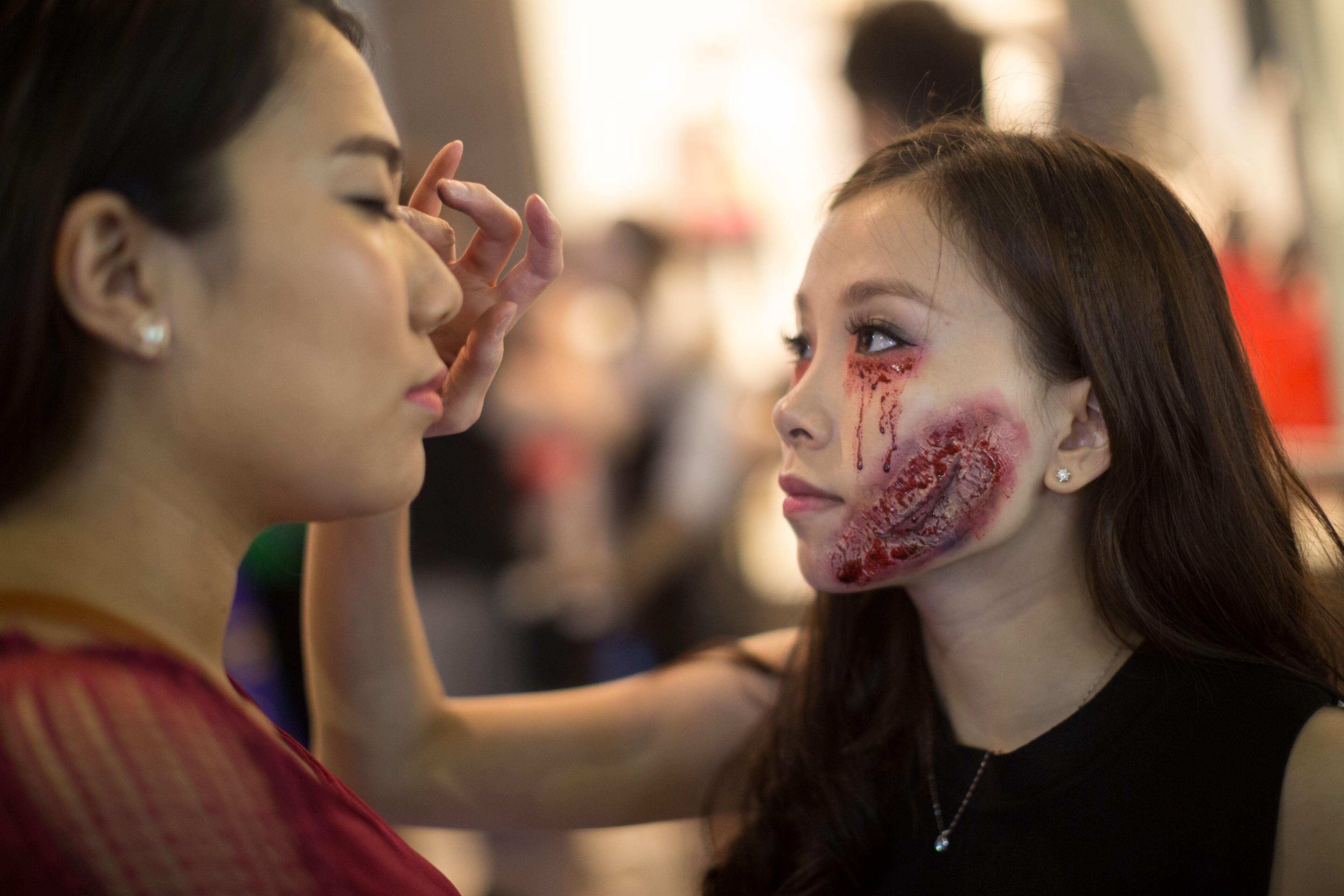 HONG KONG - OCTOBER 31: Participants make up during a Halloween event on October 31, 2015 in Lan Kwai Fong, Central District, Hong Kong. Halloween, a named taken from 'All Hallows' Even' falls on the day before All Saints' Day on November 1, a holiday when Christians remember their deceased loved ones. (Photo by Jerome Favre/Getty Images)