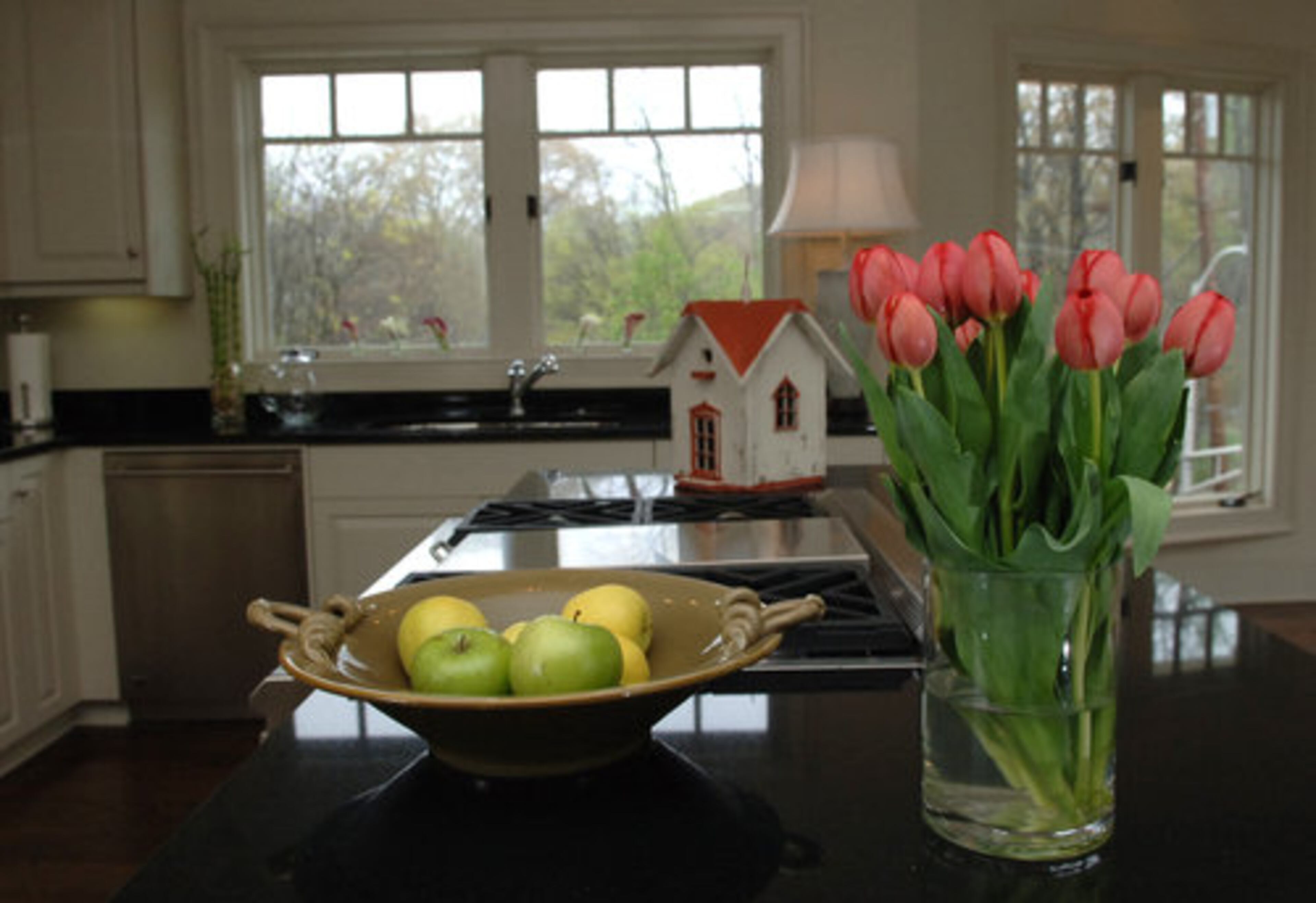 This view of the kitchen from the living room shows the Craftsman detailing on the windows.