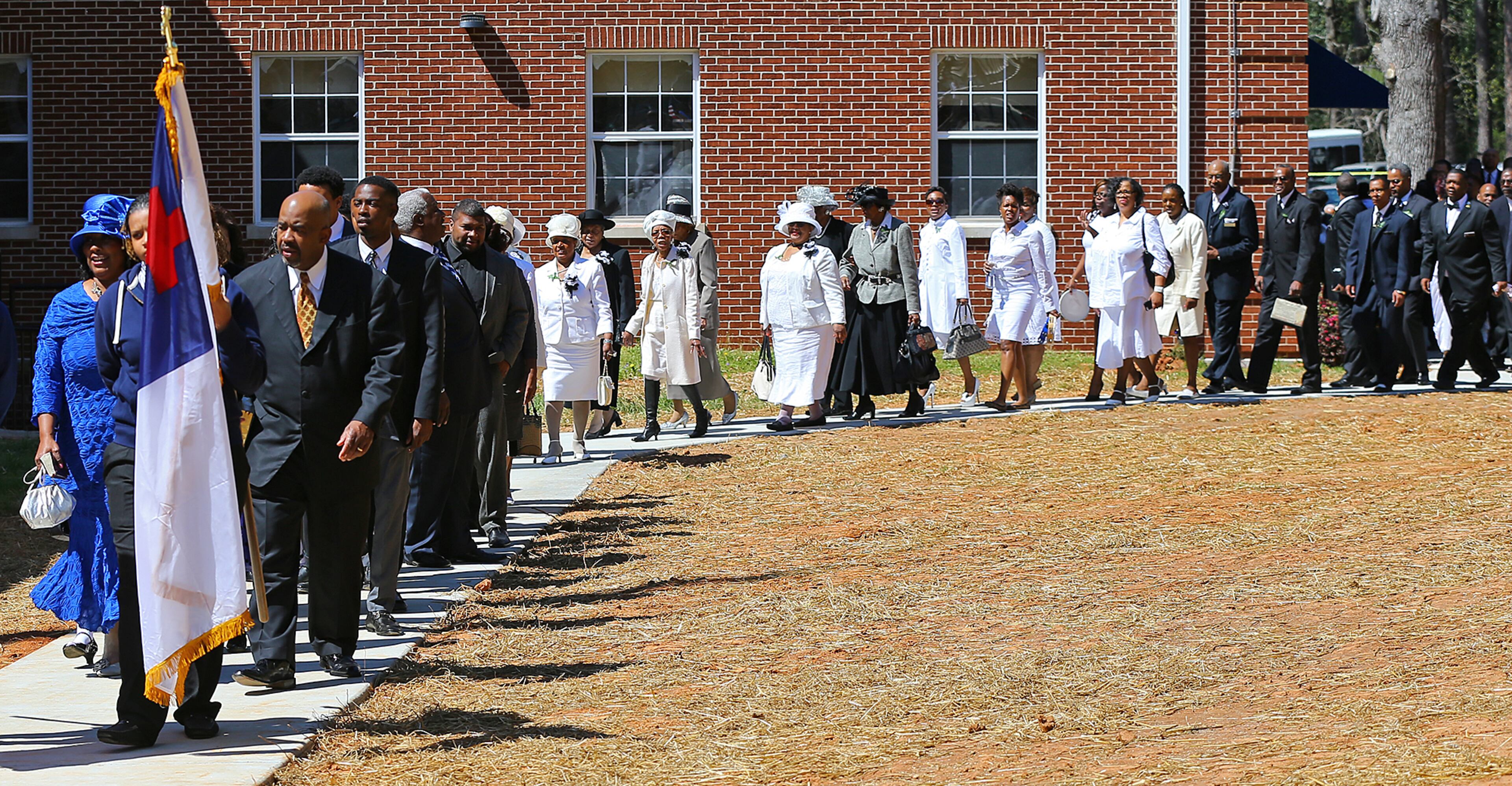 Pastor R.K. Turner and First Lady LaNett Turner (left) lead the congregation in the entrance processional for the Entrance Service at Mount Vernon Baptist Church on Palm Sunday, March 29, 2015, in Atlanta. The church moved locations to make way for the Falcons new stadium. Curtis Compton / ccompton@ajc.com