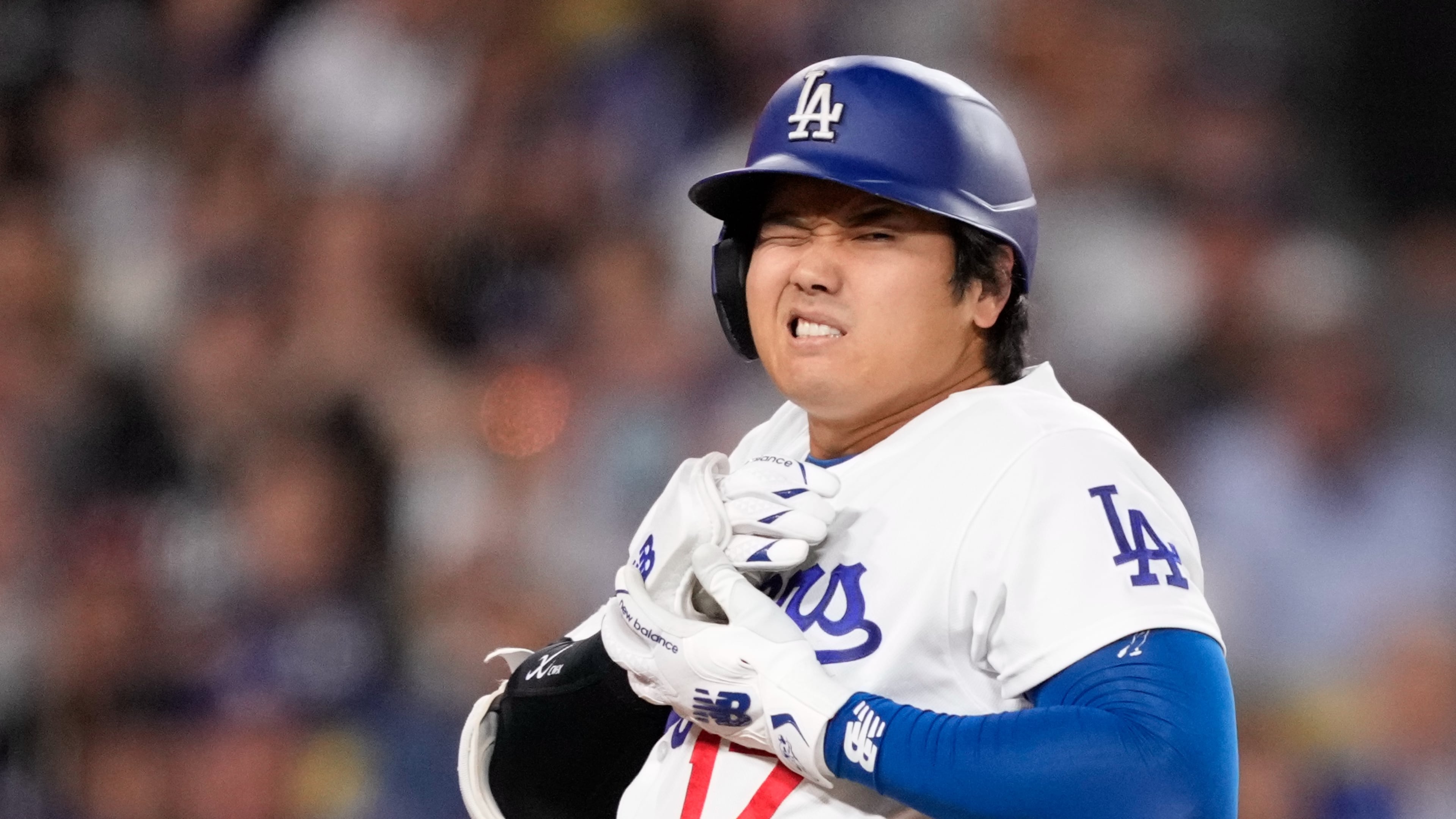 Los Angeles Dodgers' Shohei Ohtani reacts after being hit by a pitch during the fourth inning of a baseball game against the Colorado Rockies, Tuesday, May 26, 2026, in Los Angeles. (AP Photo/Mark J. Terrill)