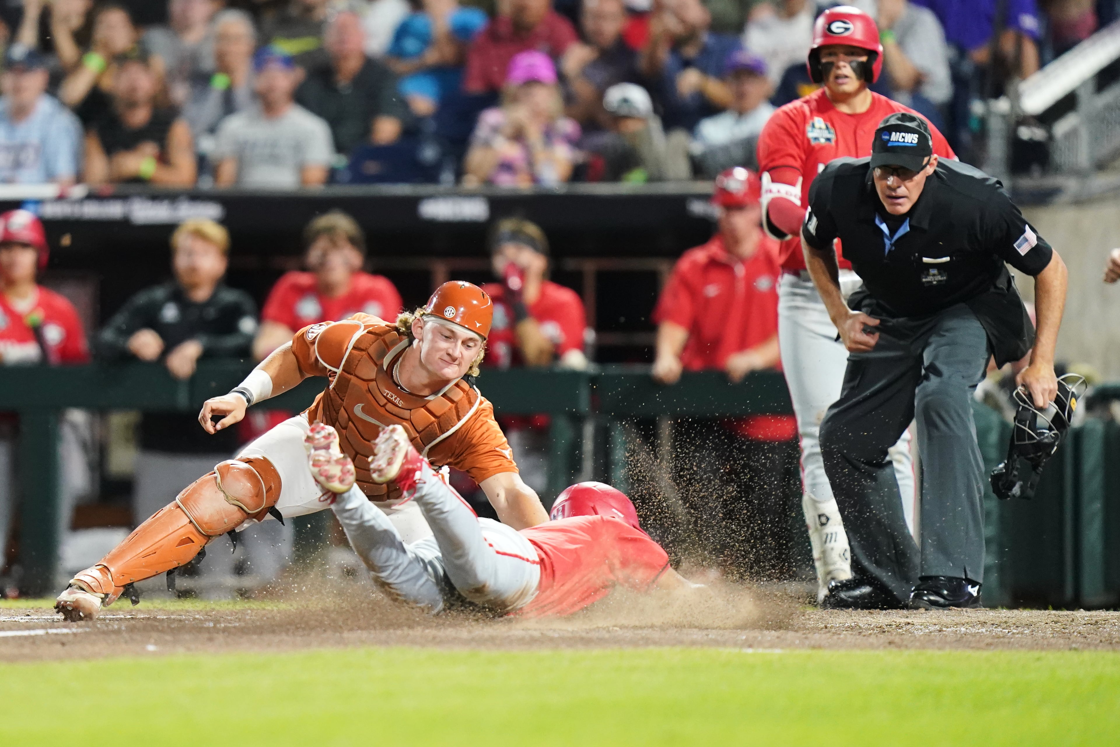 Georgia infielder Ryan Black (2) slides safely into home and scores the second run of the game in the seventh inning during an NCAA baseball College World Series elimination game against Texas, Tuesday, June 16, 2026 in Omaha, Neb. Georgia won 2-0. (AP Photo/Vera Nieuwenhuis)