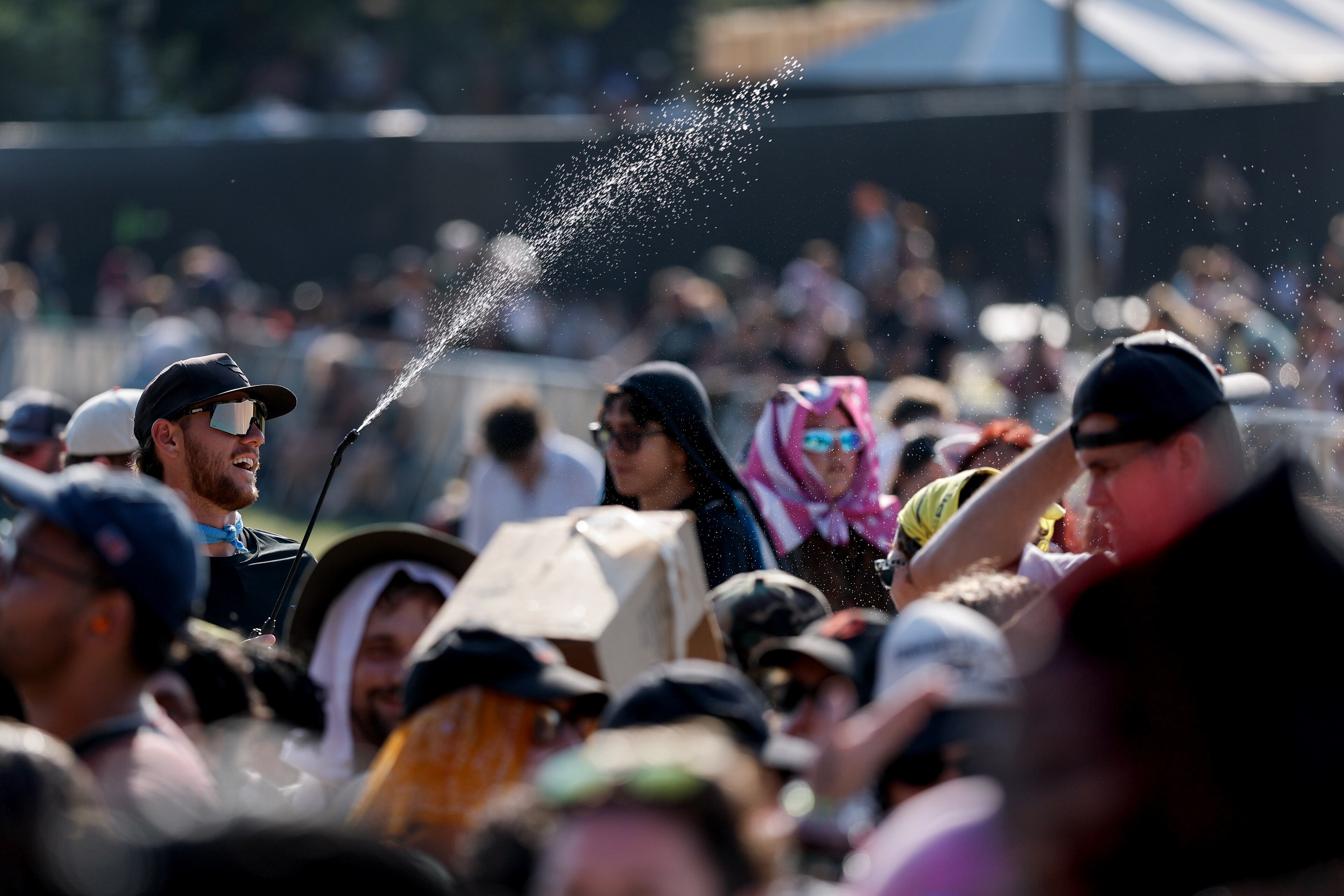 Fans try to keep cool as Peach Pit performs during the Shaky Knees music festival at Piedmont Park, Saturday, Sept. 19, 2026, in Atlanta. (Erik S. Lesser for the AJC)