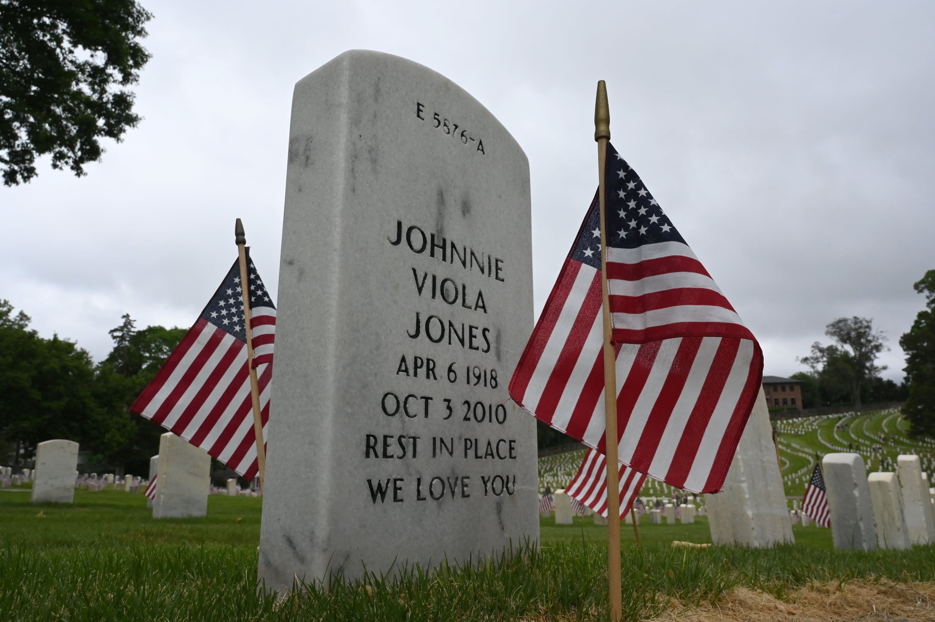 Flags are placed at headstones during the Memorial Day Flag Placement event at Marietta National Cemetery on Saturday, May 23, 2026, in Marietta. Scouting groups in the community place more than 18,000 U.S. veteran grave flags at Marietta National Cemetery each year on the Saturday before Memorial Day, helping prepare for Monday’s ceremony. The long-running service project—organized with the National Memorial Day Association of Georgia—also gives youth and adults an opportunity to honor fallen service members and learn about their sacrifices and the area’s history. (Hyosub Shin/AJC)