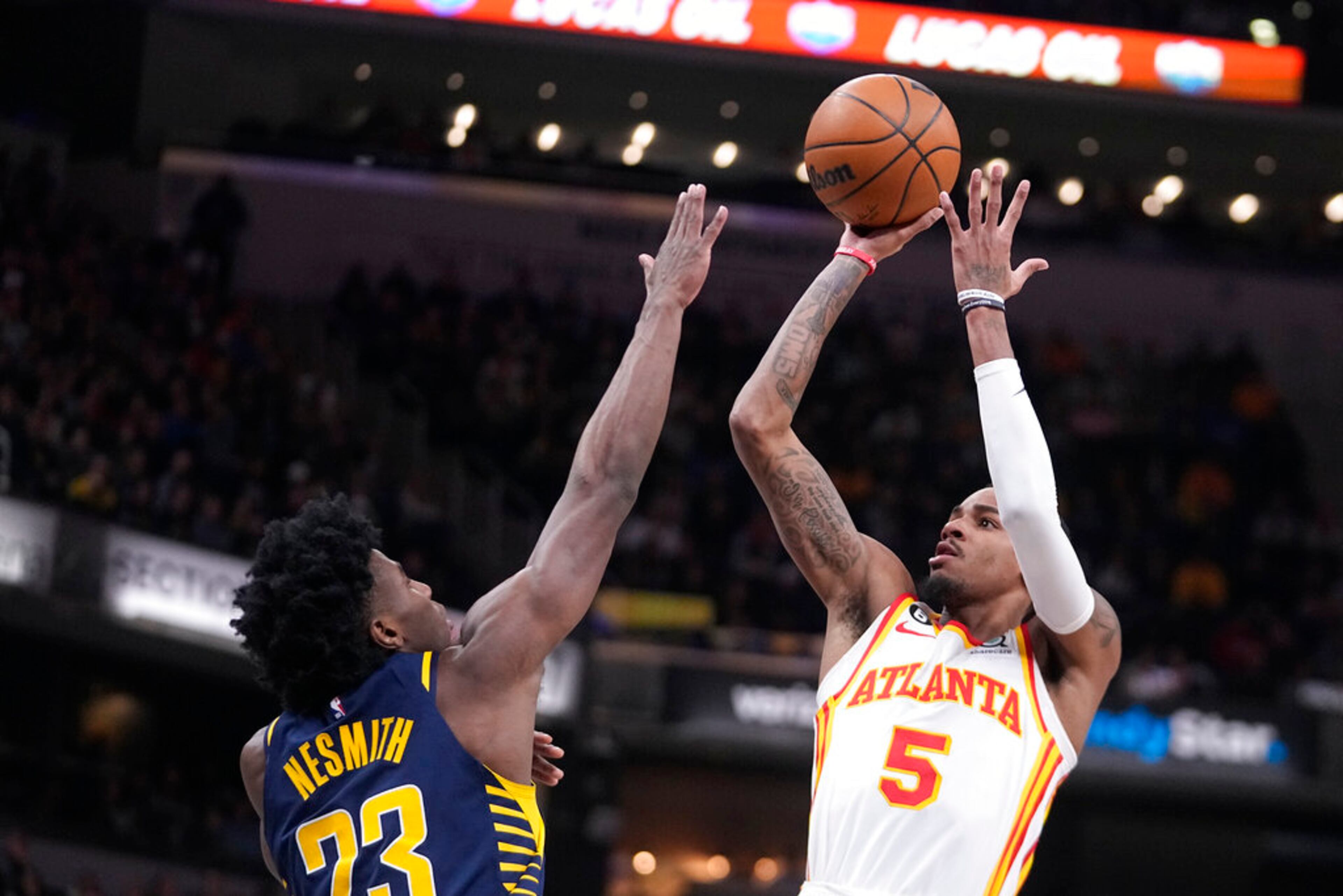Atlanta Hawks' Dejounte Murray (5) shoots over Indiana Pacers' Aaron Nesmith during the first half of an NBA basketball game Tuesday, Dec. 27, 2022, in Indianapolis. (AP Photo/Darron Cummings)