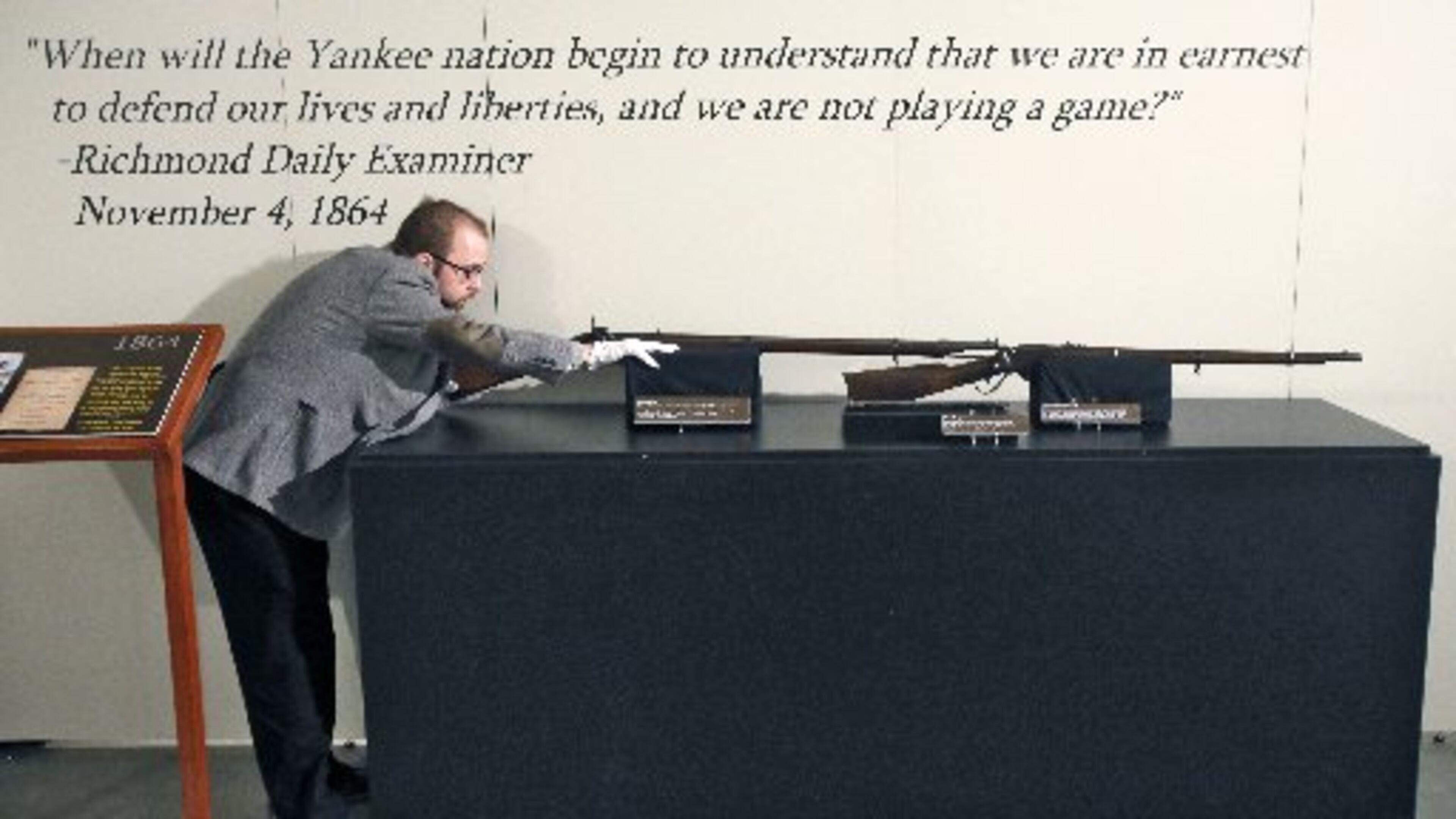Southern Museum curator Jonathan Scott with rifles on display in the exhibit "1864." BOB ANDRES/ BANDRES@AJC.COM