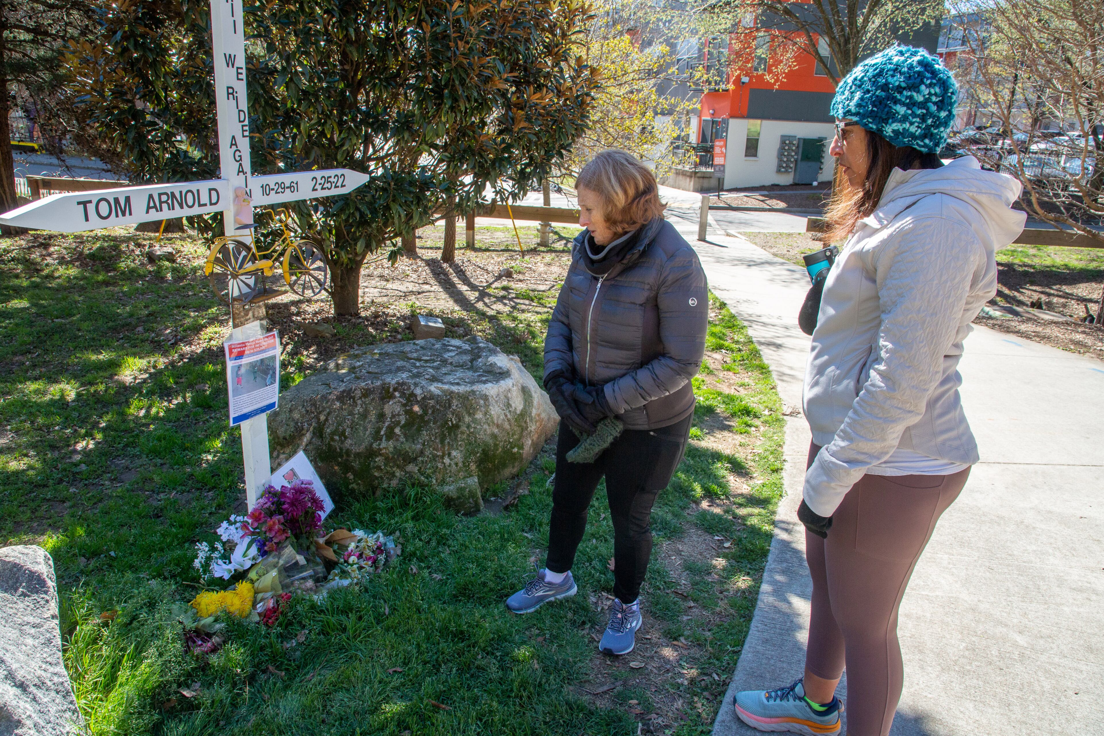 Susan Levy (left) and Amy El-Bassioni stand at the memorial for Thomas Arnold near the Beltline on Sunday, March 13, 2022. (AJC File)