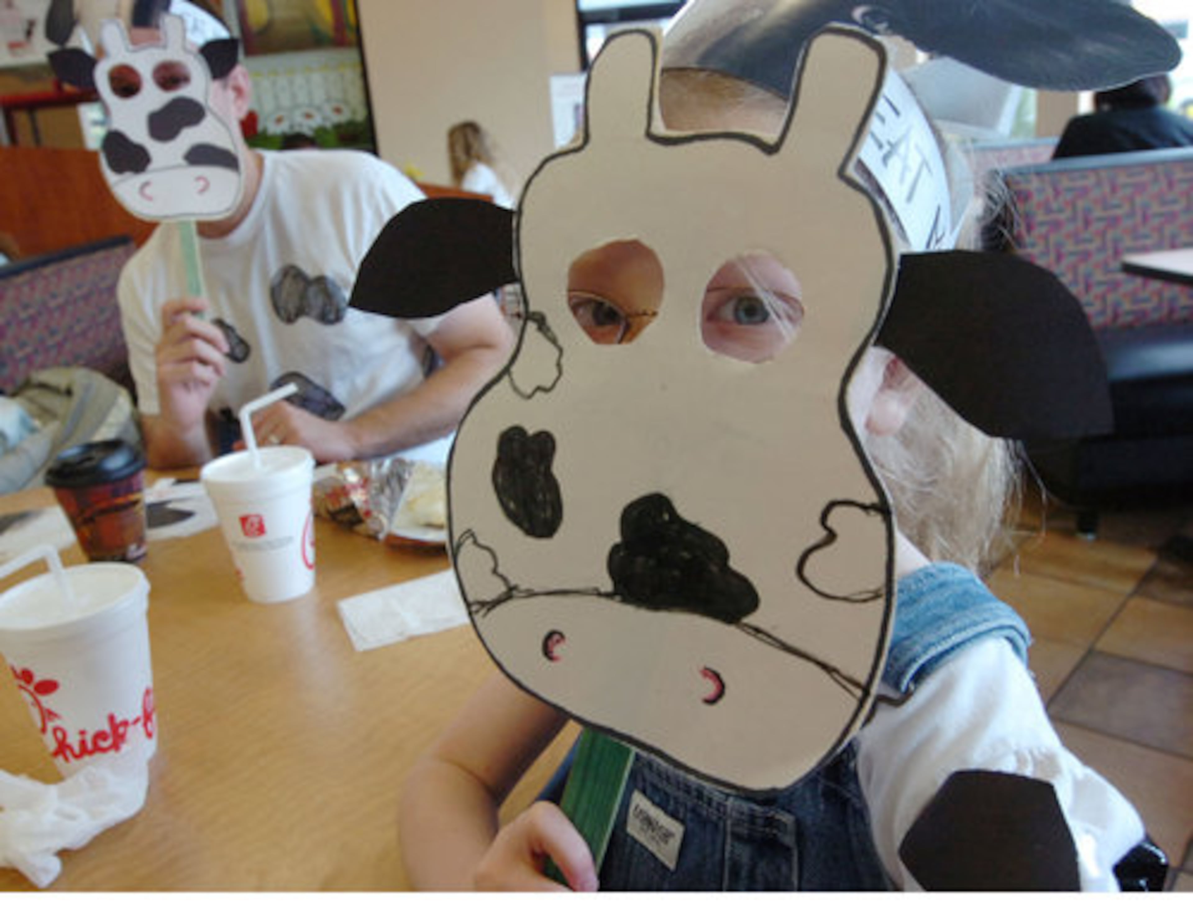 Ed Wiley (left) of Smyrna and his daughter Julia, 7, visit the Vinings Chick-fil-A on Cumberland Parkway. Anyone coming into a Chick-fil-A dressed in cow attire gets free food on Cow Appreciation Day.