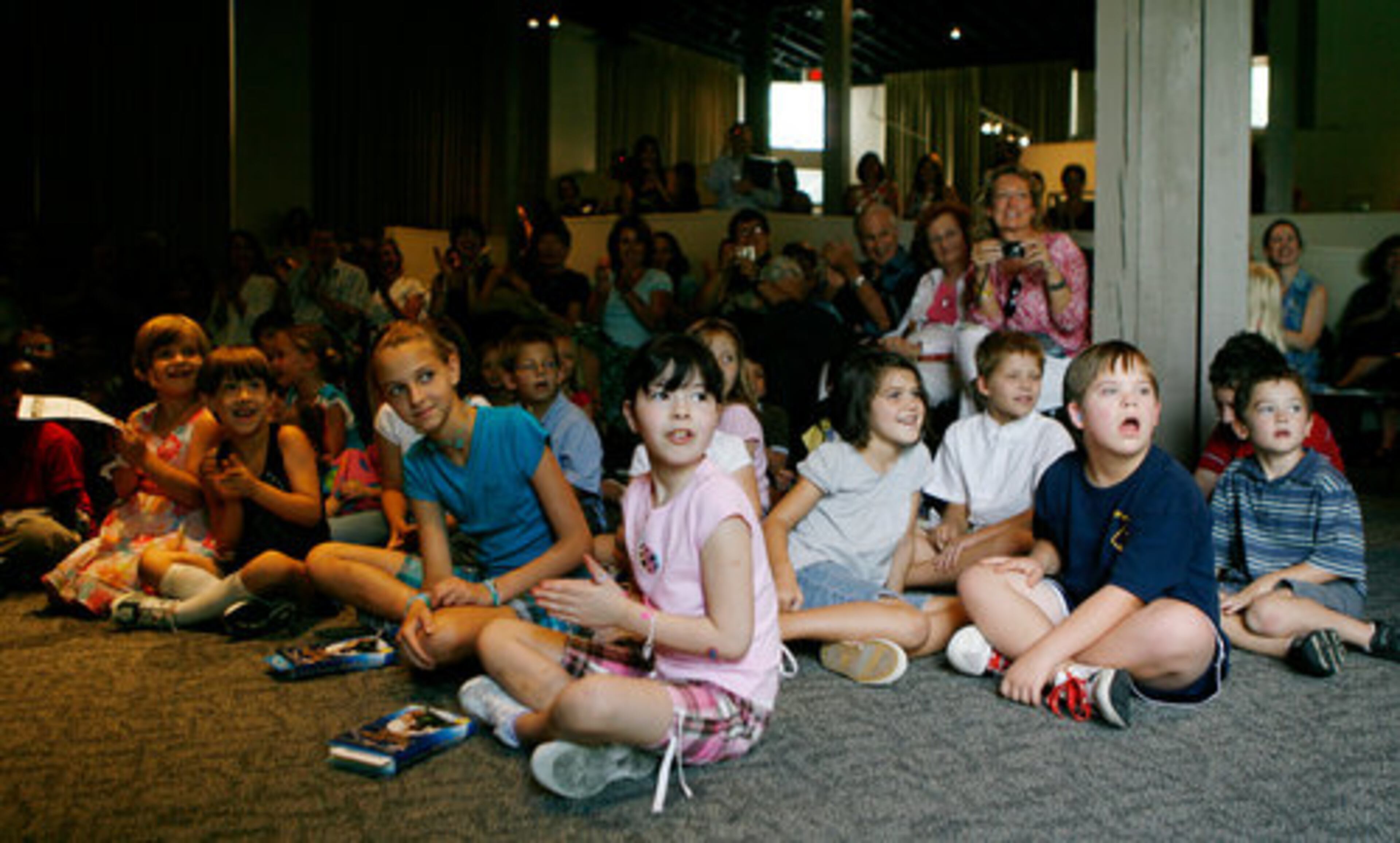 Children watch actress Emma Thompson arrive at Commercial Row at the Margaret Mitchell House on Thursday, Aug. 12, 2010.